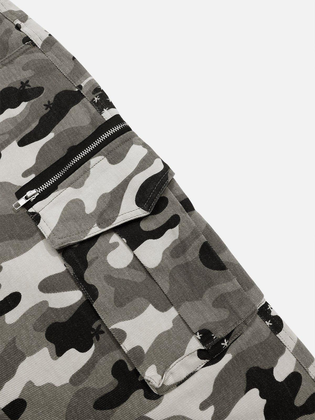 Zoomed-in view of TALISHKO camouflage jeans, highlighting the pocket detail and pattern.