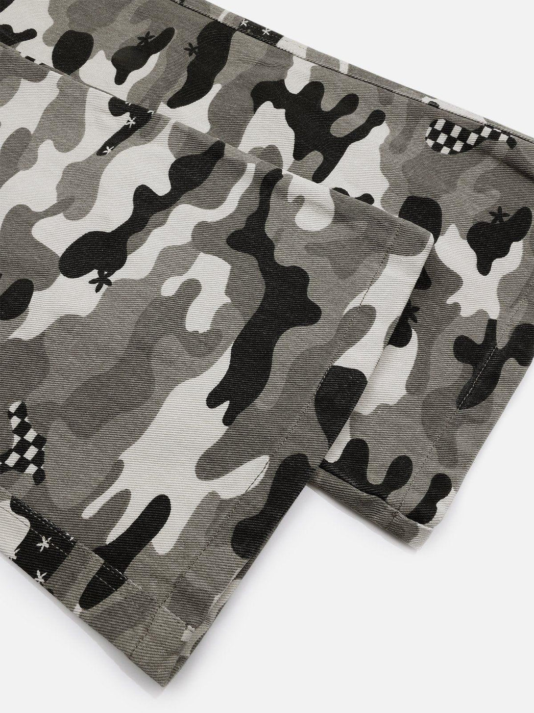 Texture and pattern showcased on TALISHKO camouflage jeans, highlighting intricate design details.