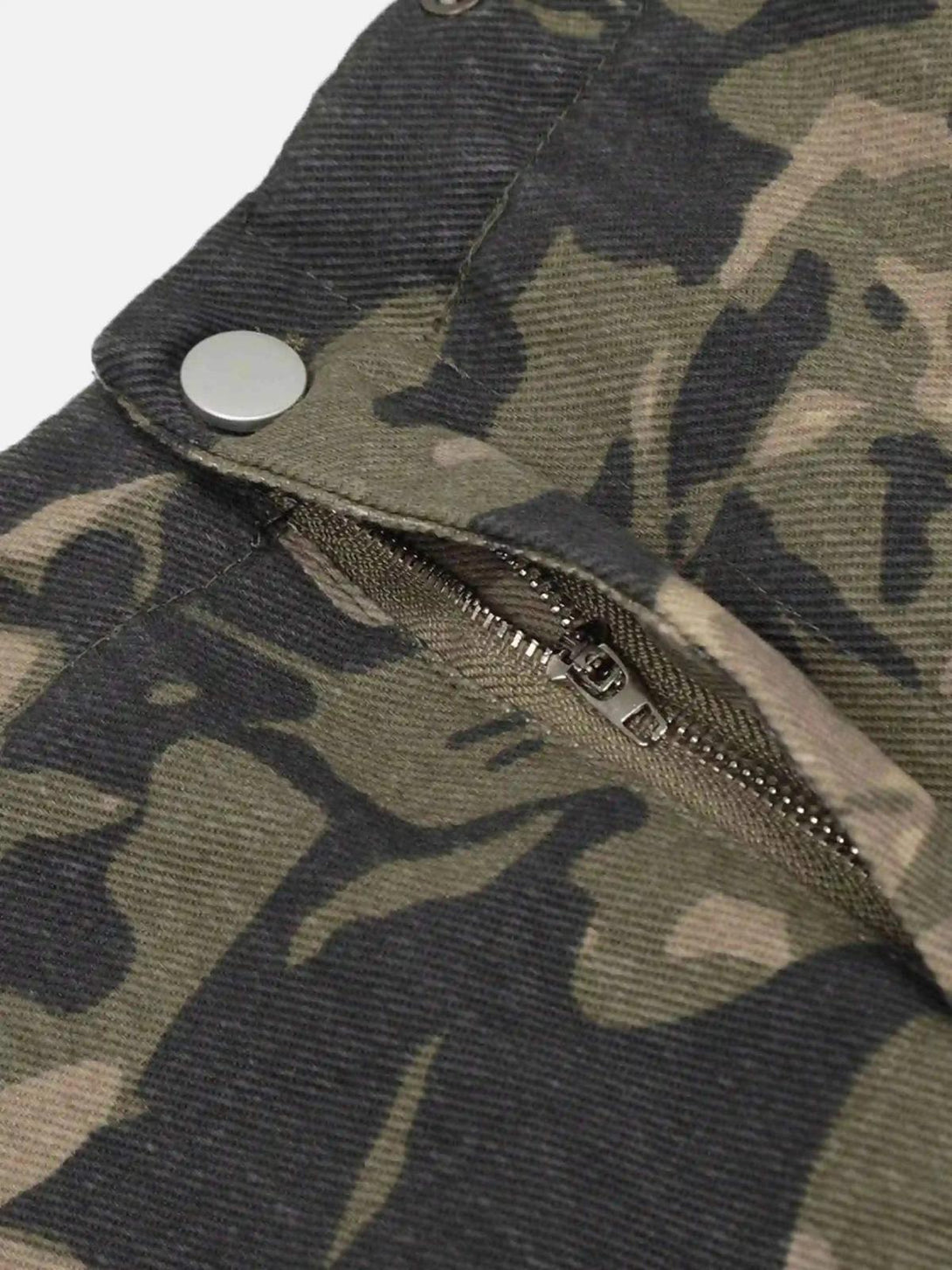 Detailed view of TALISHKO camouflage work pants highlighting the zipper and snap closure.
