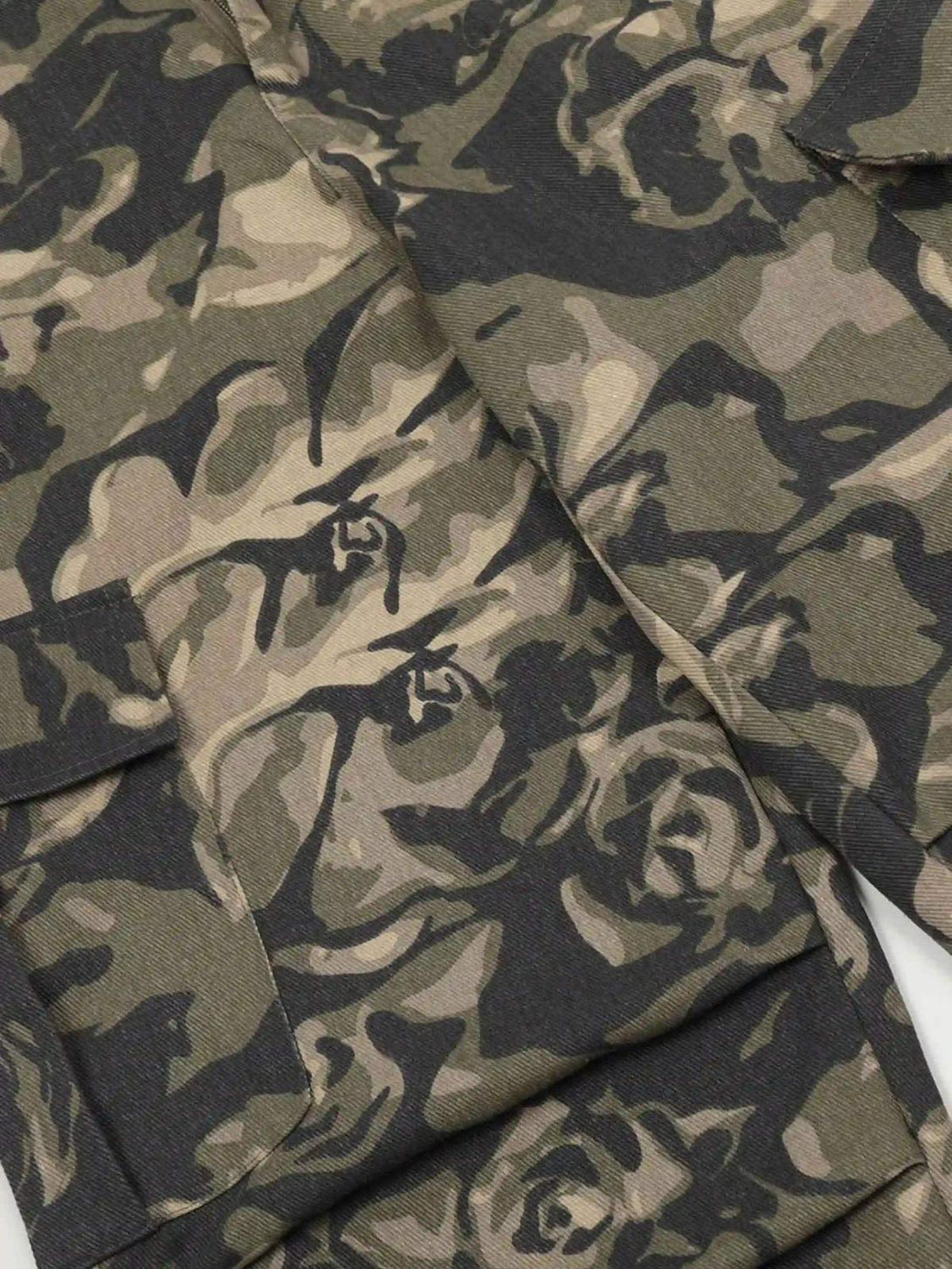 Intricate look at TALISHKO camouflage work pants, showcasing the bold pattern and durable fabric.