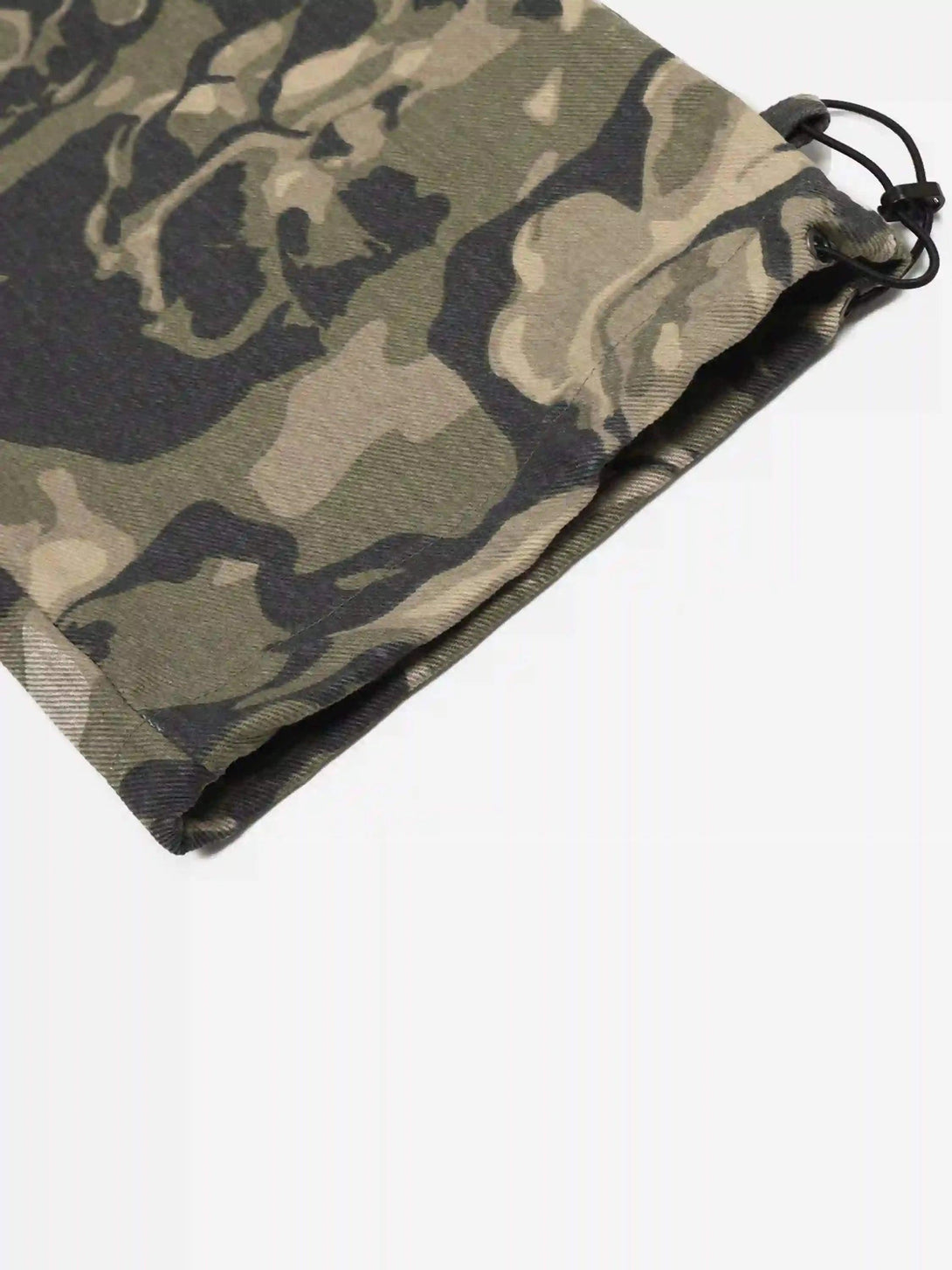 Drawstring detail on TALISHKO camouflage work pants, highlighting rugged design and texture.