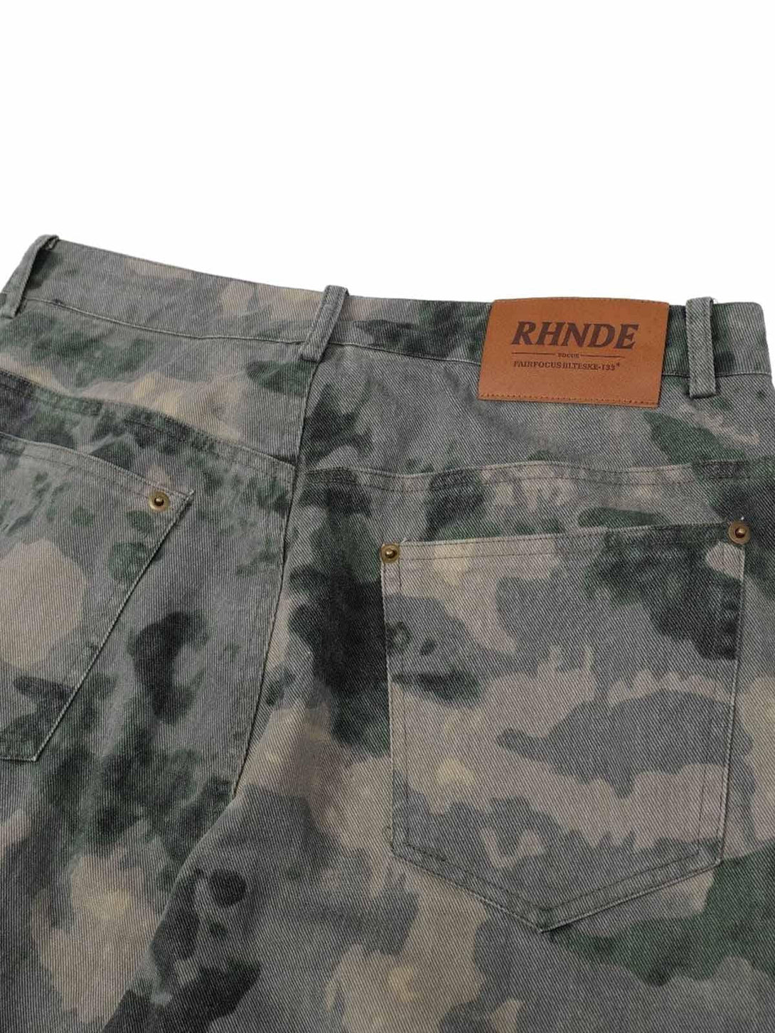 Back detail of TALISHKO camouflage cargo pants, highlighting pocket design and texture.