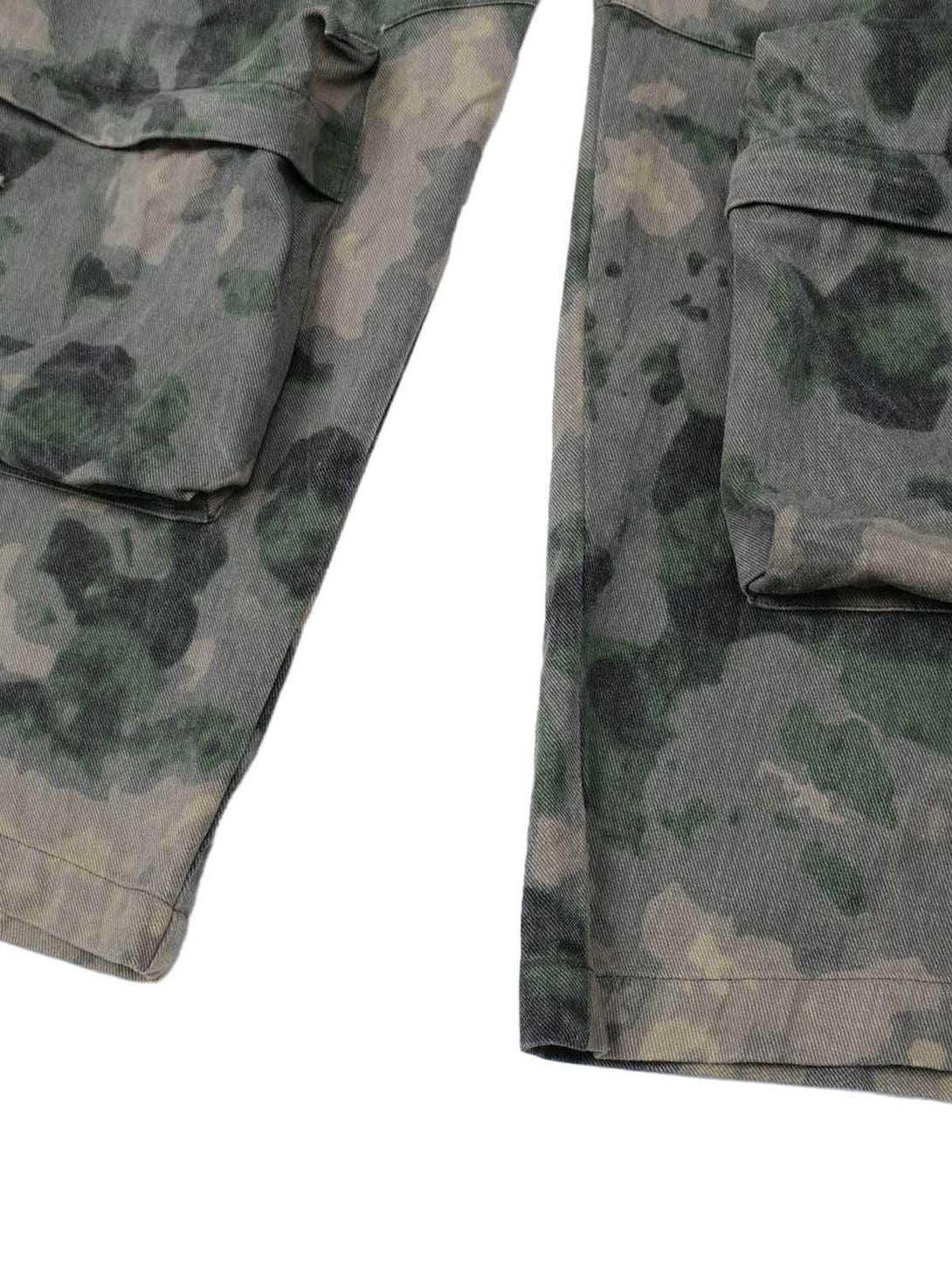 Focusing on the pocket detail of TALISHKO cargo pants, showcasing the camouflage pattern.