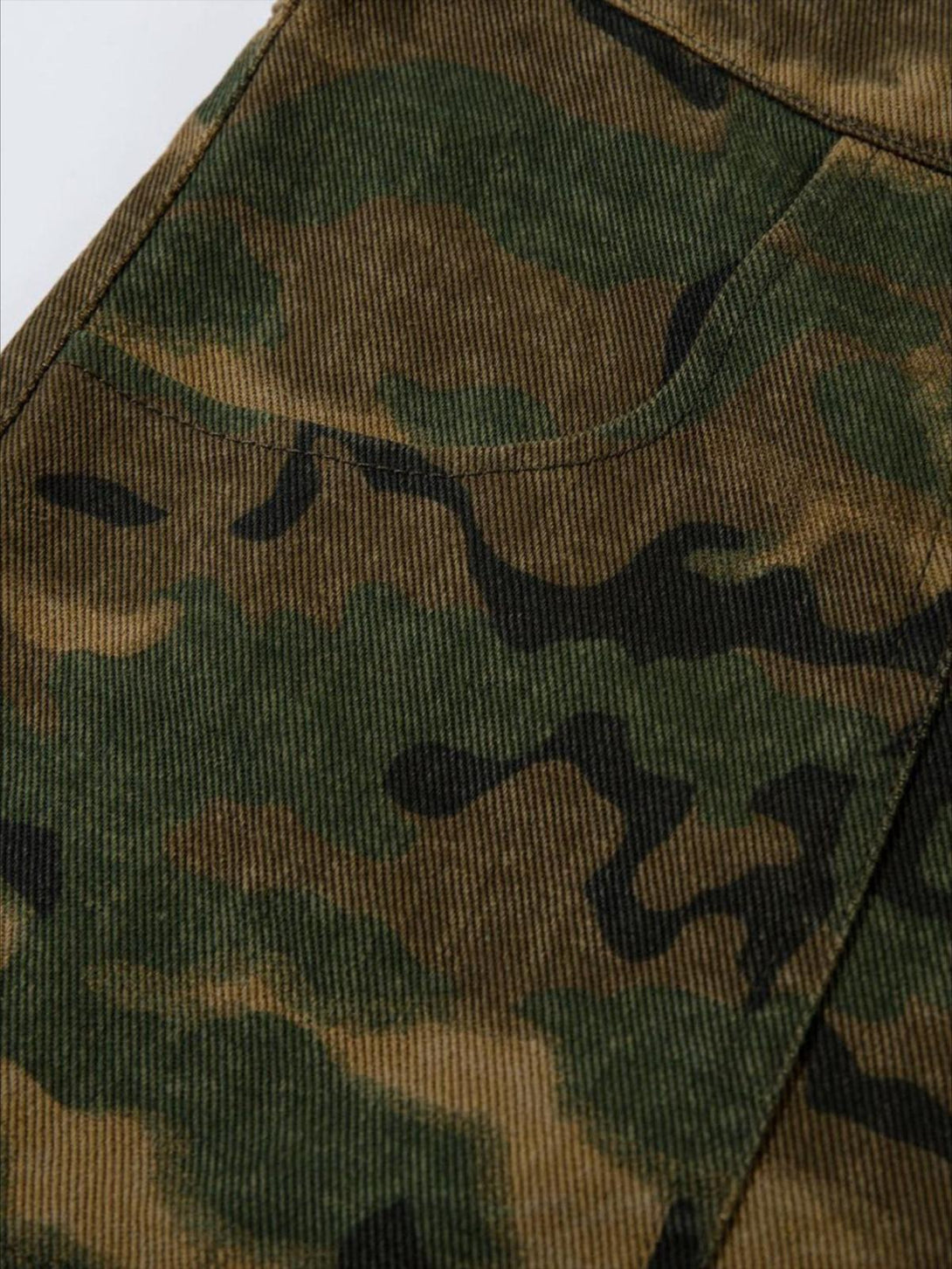 Focusing on the camouflage pattern and texture of TALISHKO denim cargo pants for a trendy look.