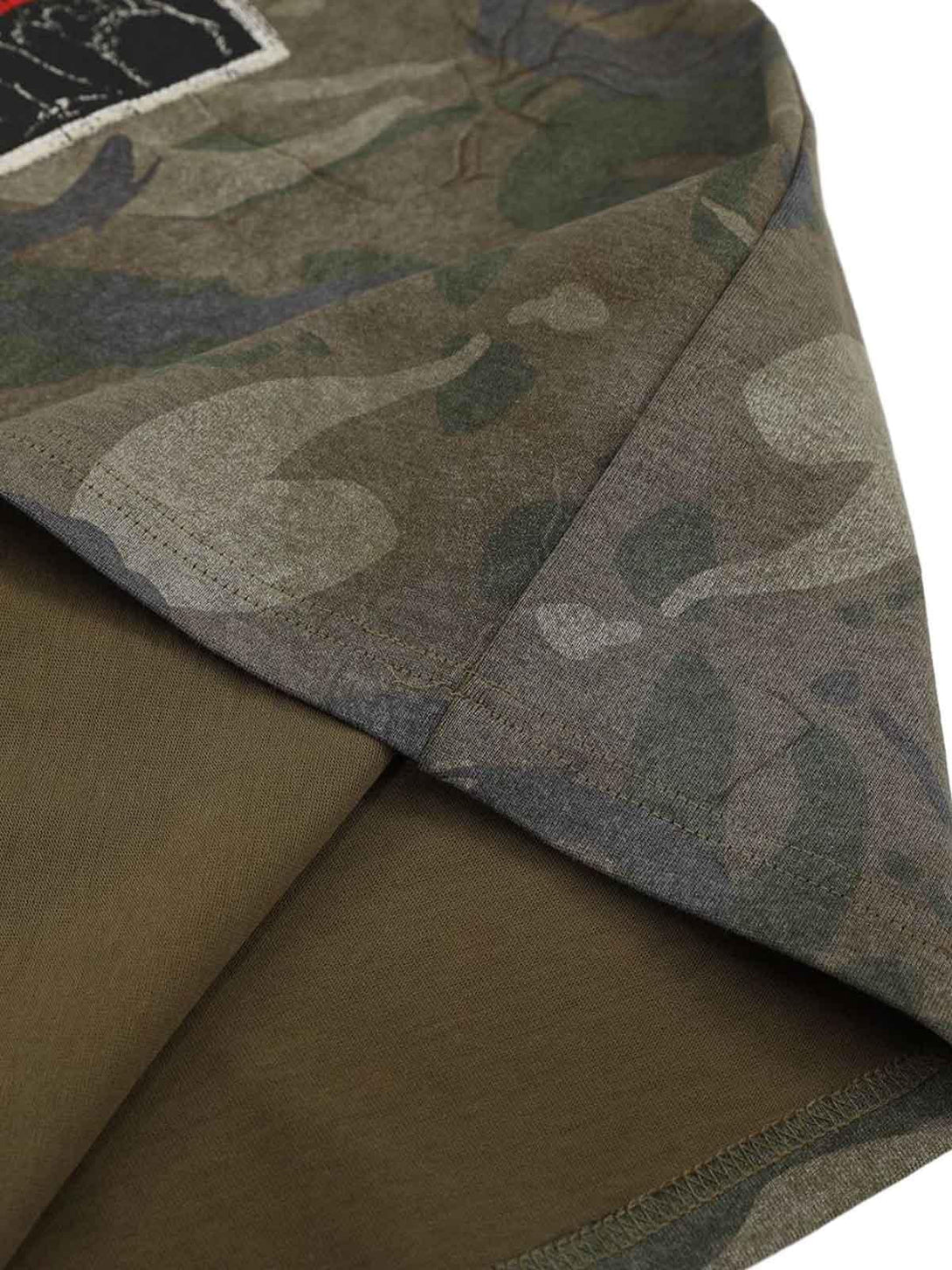 Detailed fabric and stitching on a TALISHKO camouflage patchwork graphic T-shirt.