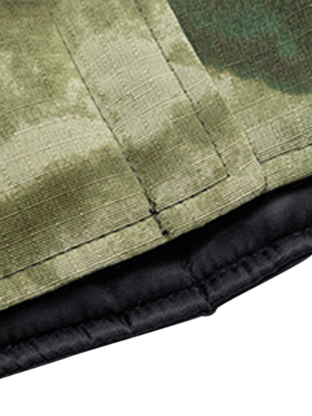 Detailed look at the TALISHKO jacket's stitching and camouflage pattern, showcasing craftsmanship.
