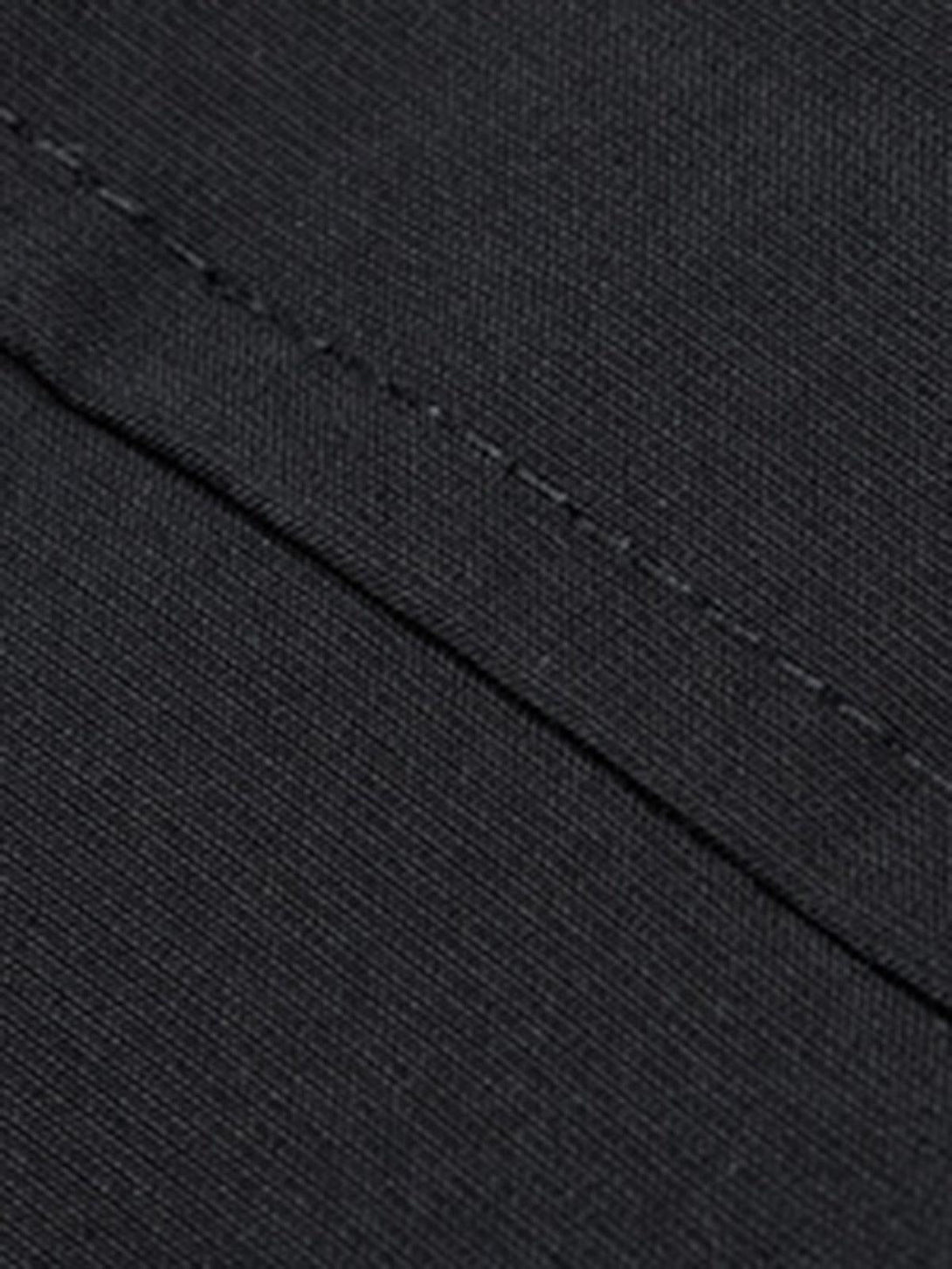 Stitching detail on TALISHKO's jacket, highlighting the sleek black fabric and craftsmanship.