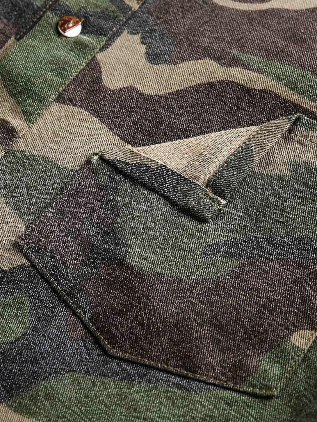 Intricate look at TALISHKO camouflage shirt pocket highlighting patchwork texture and detail.