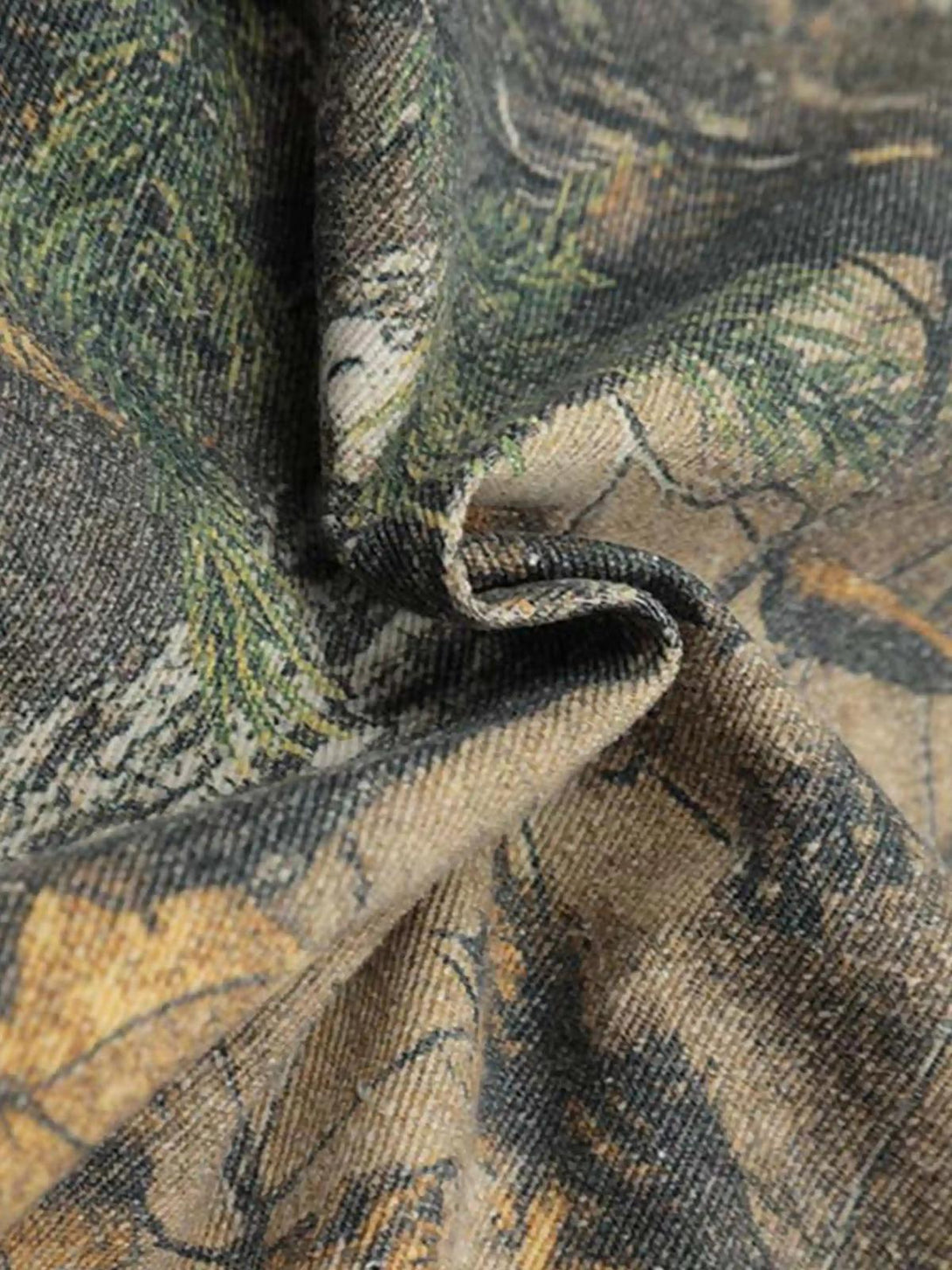 Texture and pattern showcased on a TALISHKO hoodie, highlighting its camouflage design.
