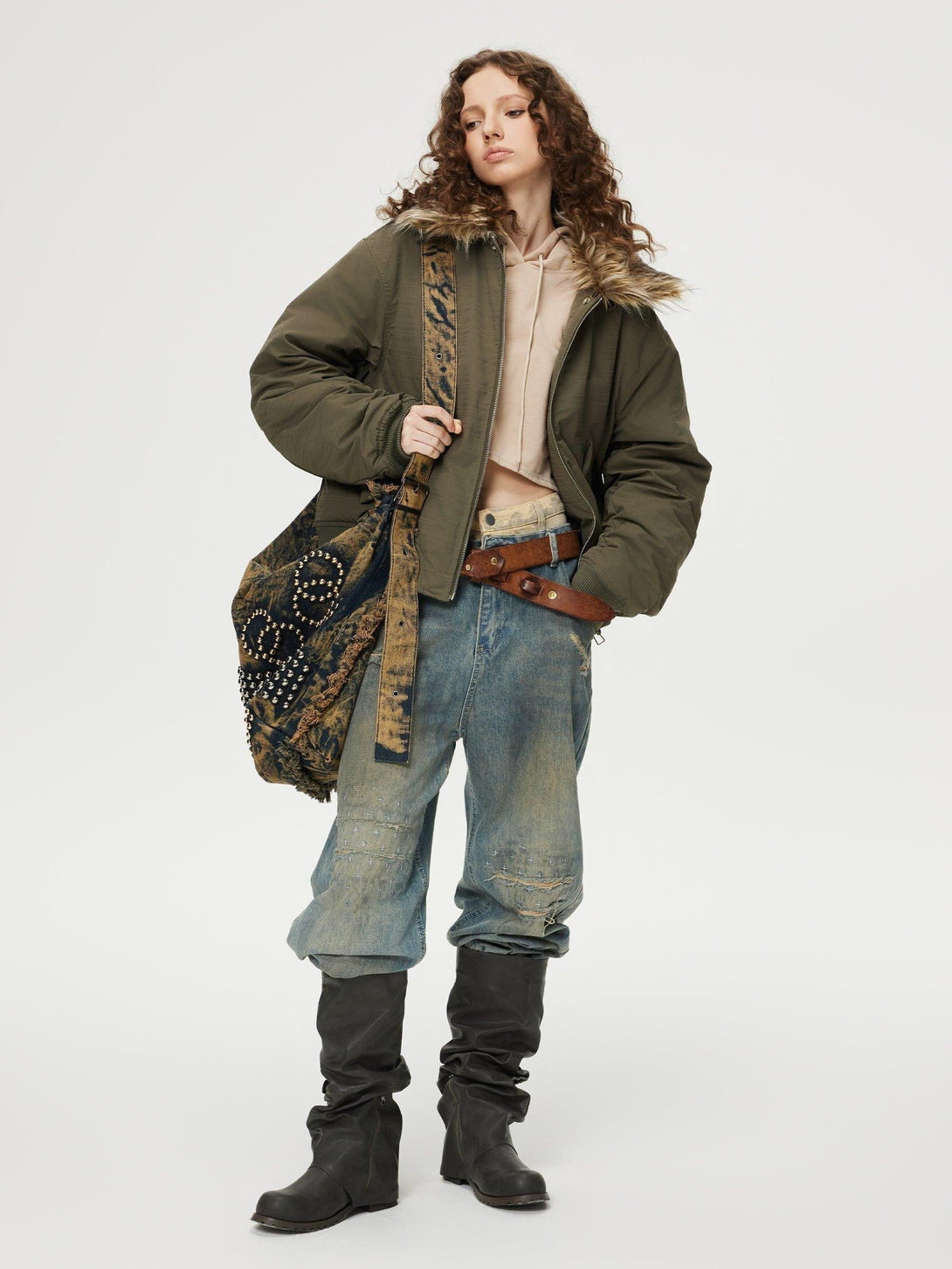 Model wearing TALISHKO sagging jeans, paired with a cozy jacket and stylish boots.