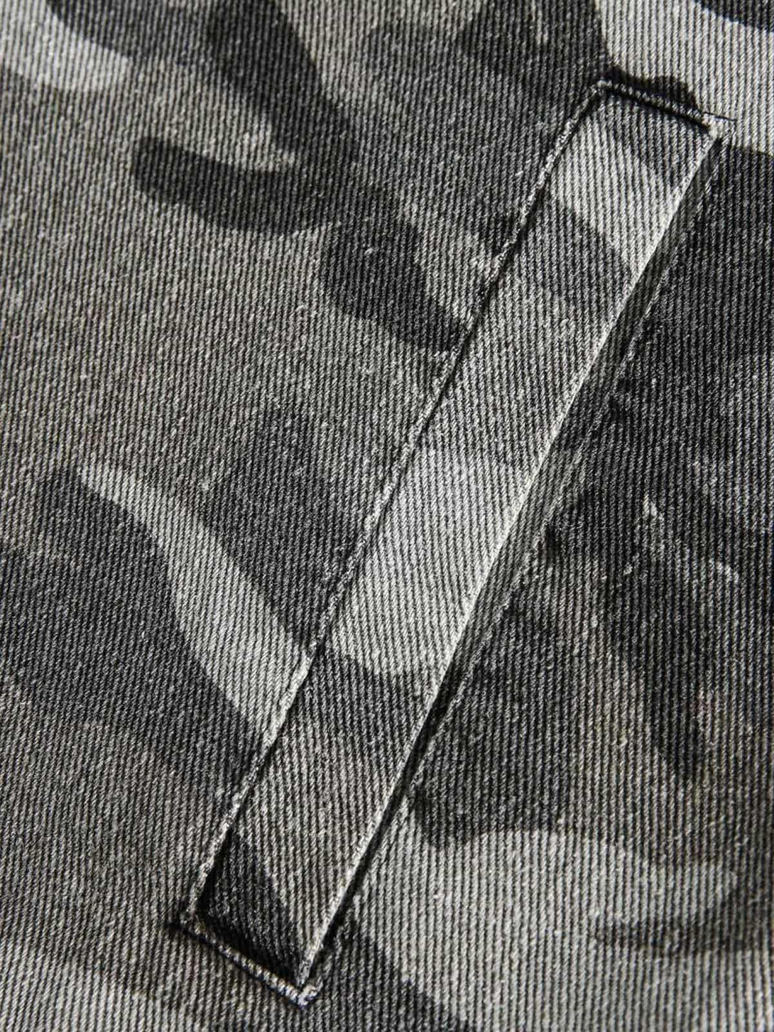 Detailed fabric and stitching on TALISHKO camouflage military jacket, highlighting its rugged texture.