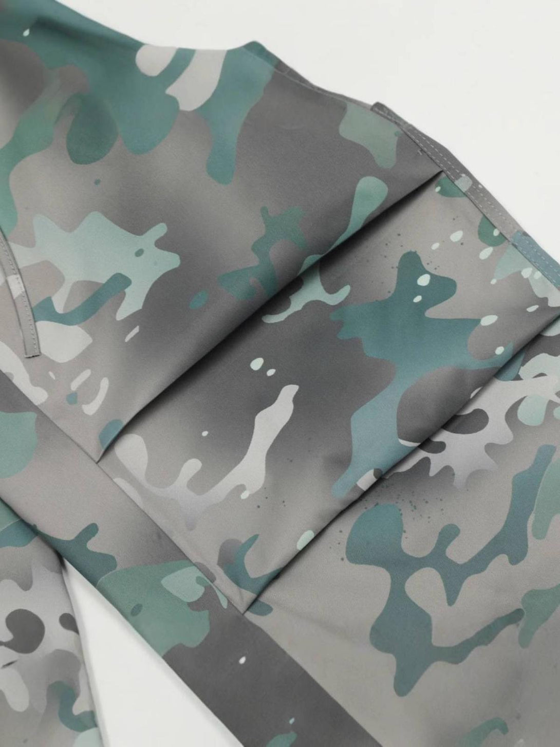 A detailed view of the camouflage tie-dye pattern on TALISHKO cargo pants, highlighting texture.