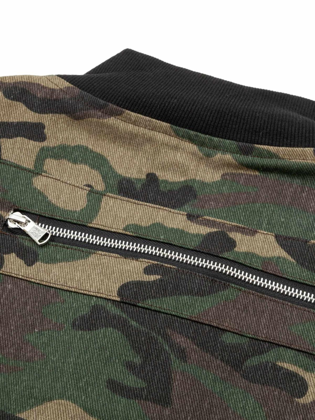 A close-up of the camouflage bomber jacket's zipper and collar detail, designed by TALISHKO.