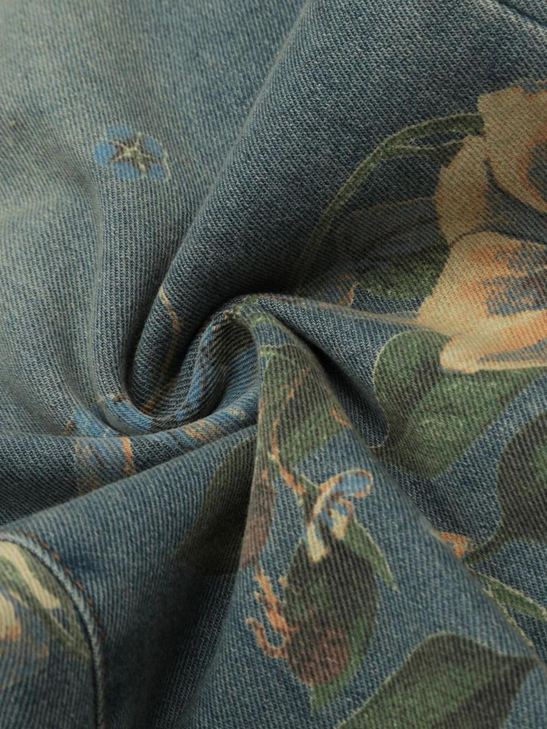 Texture and pattern showcased on TALISHKO's floral carpenter pants, highlighting intricate design.