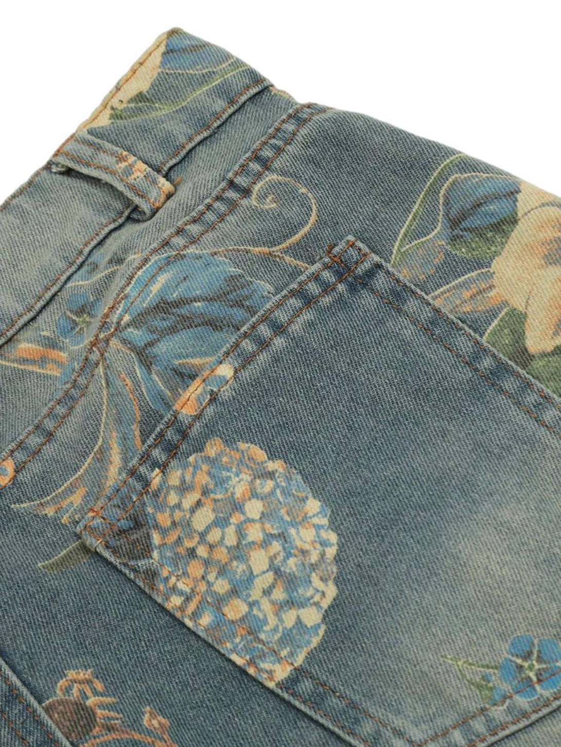 Detailed fabric and stitching on TALISHKO's floral carpenter pants, highlighting the intricate design.
