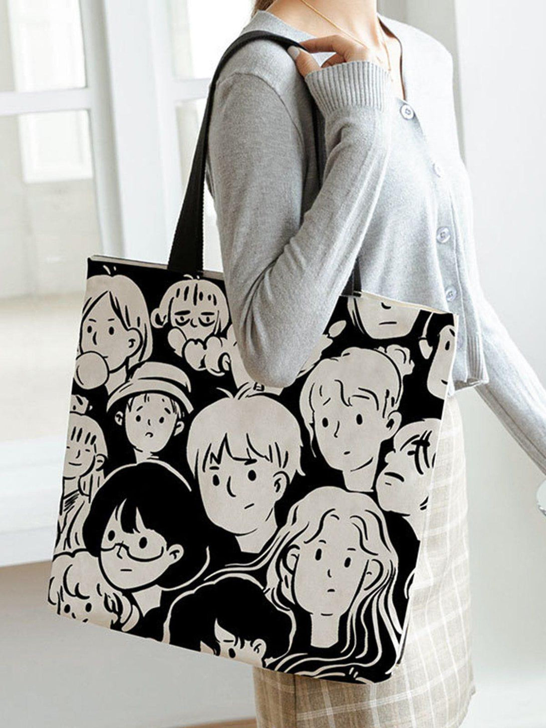 TALISHKO cartoon character print tote bag adds a playful touch to any casual outfit.
