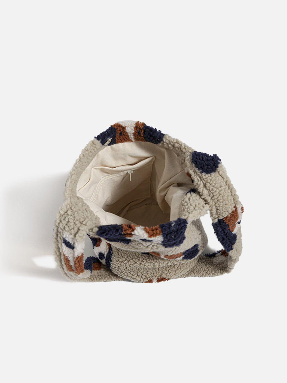A detailed view of the TALISHKO plush bag's cozy interior, featuring a playful cartoon dog pattern.