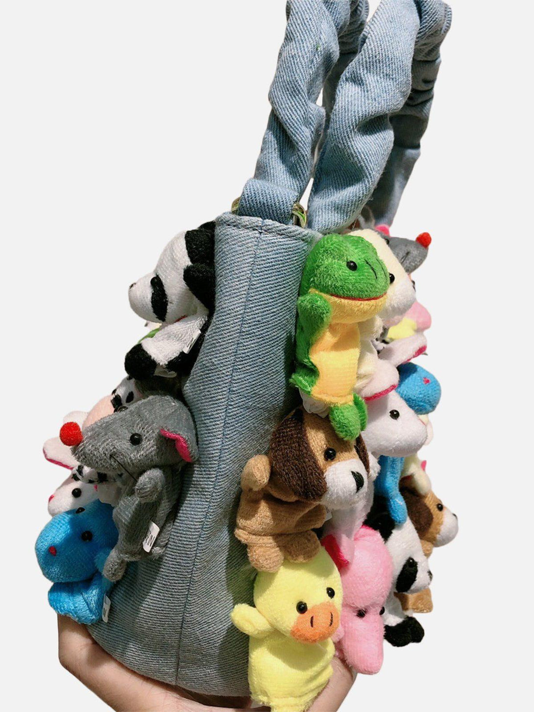 TALISHKO's denim bag with adorable cartoon animal dolls, adding a fun and unique flair.