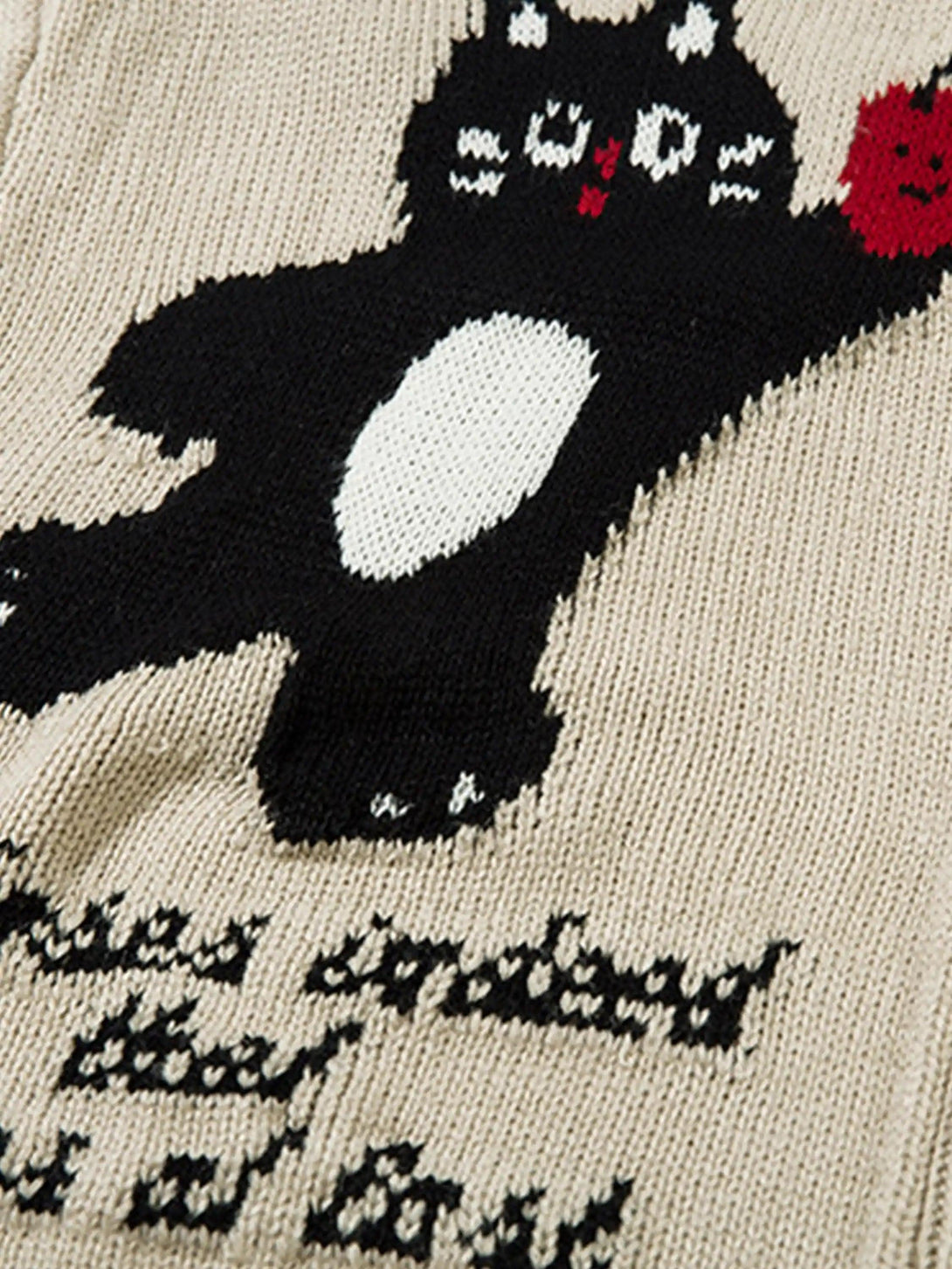 A detailed look at the cartoon pet design on a knitted cardigan by TALISHKO.