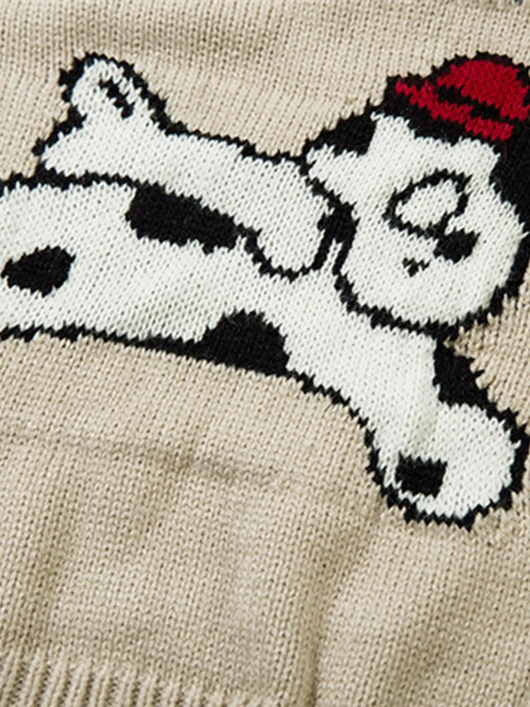 A close-up of a playful cartoon pet design on a knitted cardigan by TALISHKO.