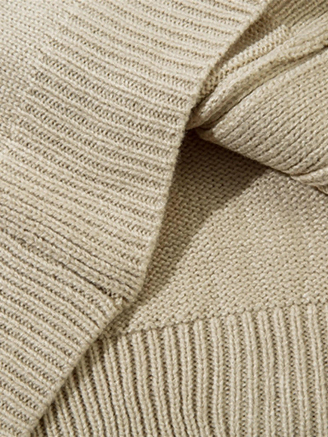 Intricate look at ribbed texture on TALISHKO's knitted cardigan, showcasing fine craftsmanship.