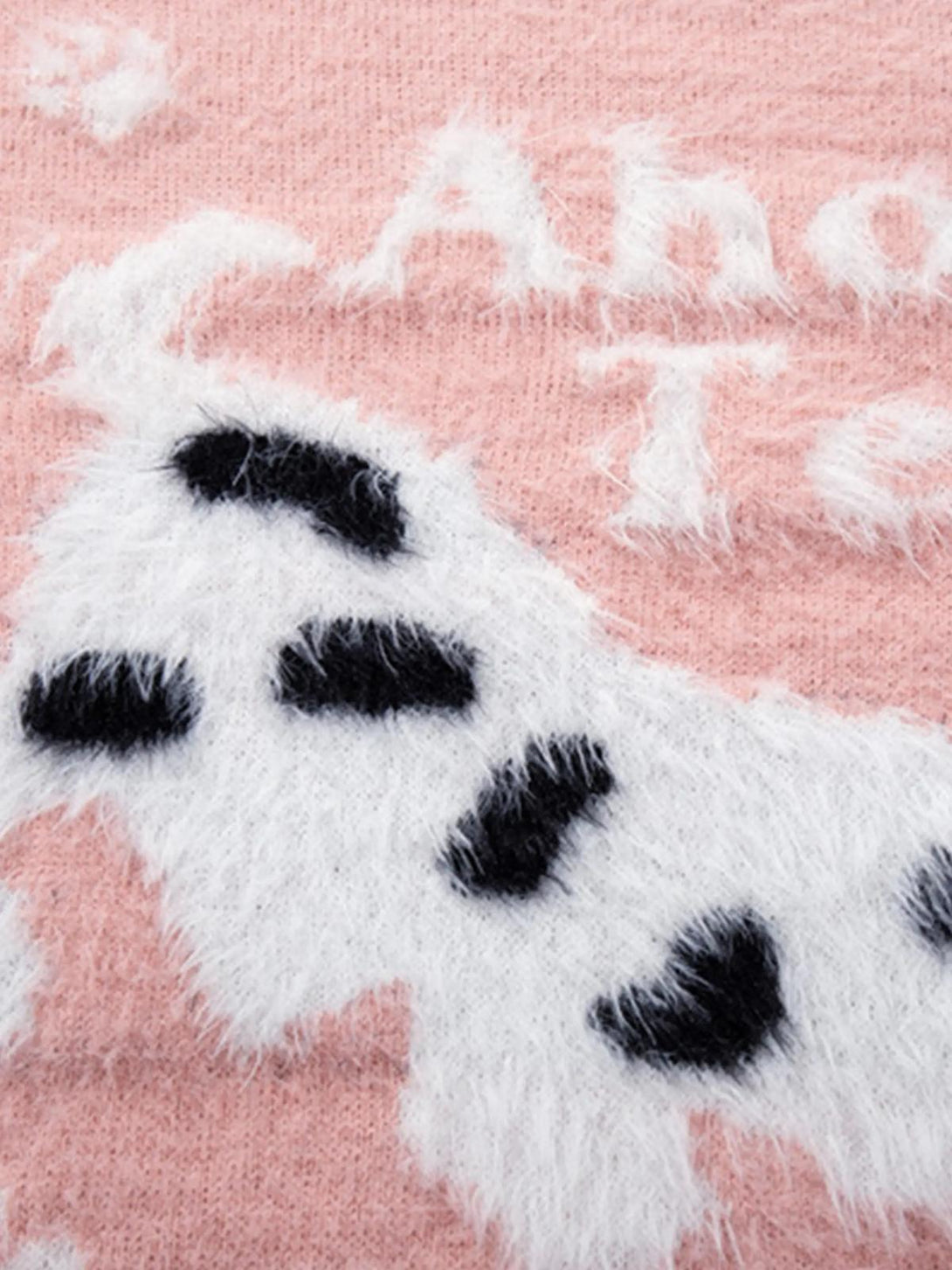 Zoomed-in texture of TALISHKO's pink sweater, featuring a fluffy spotted puppy design.