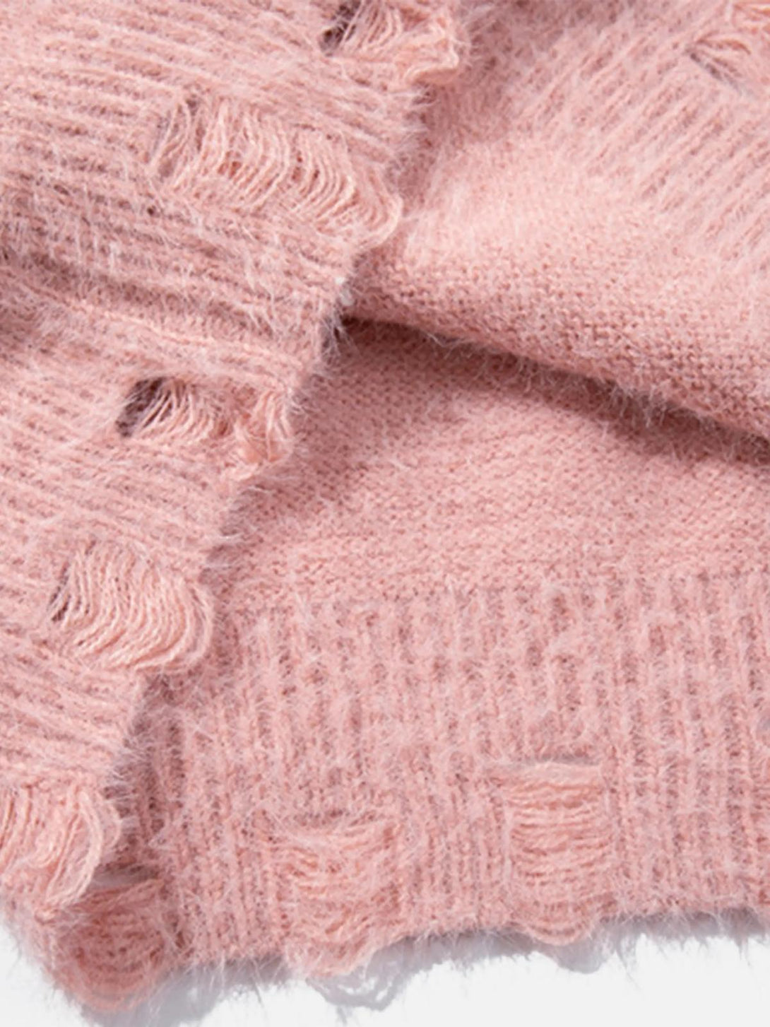Focusing on the soft texture of TALISHKO's pink sweater, highlighting its fluffy knit detail.