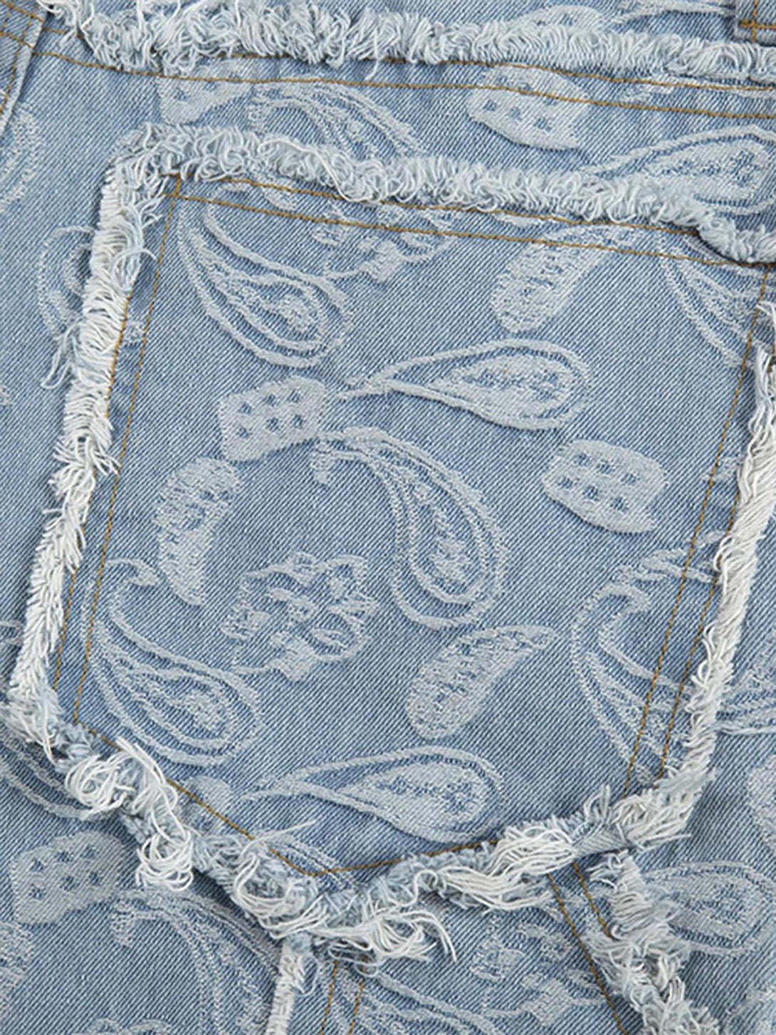 Intricate look at the paisley pattern and frayed pocket detail on TALISHKO's jeans.