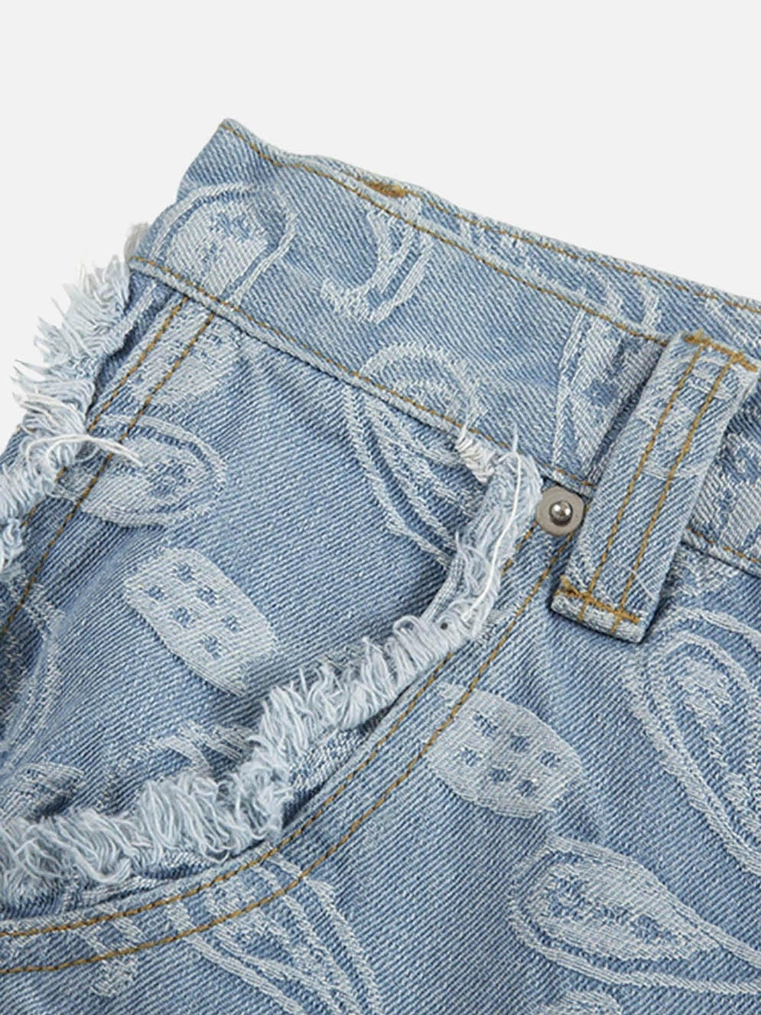 Detailed fabric and stitching on TALISHKO's jeans, highlighting the frayed edges and paisley.