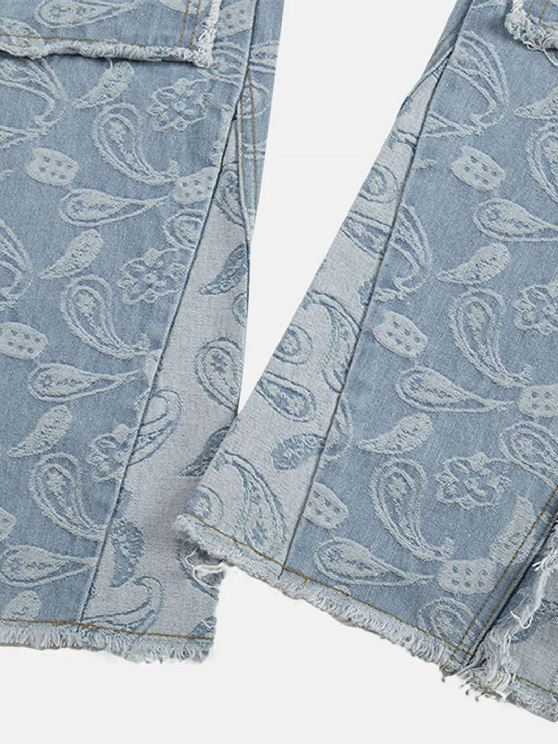 A detailed view of TALISHKO's cashew flower cut jeans, featuring frayed hems and paisley design.