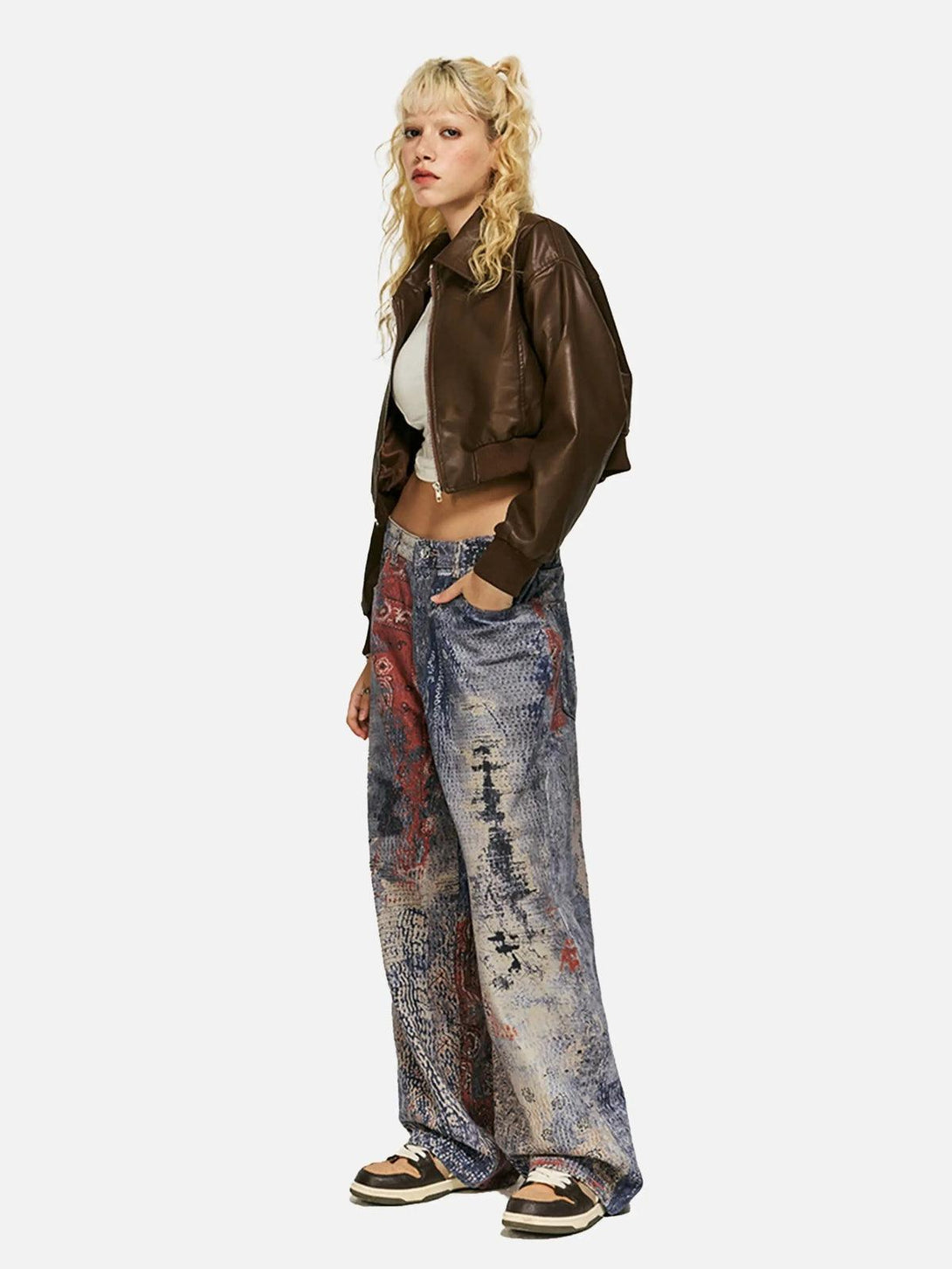 Model in TALISHKO's digital print imitation jeans, styled with a brown leather jacket.