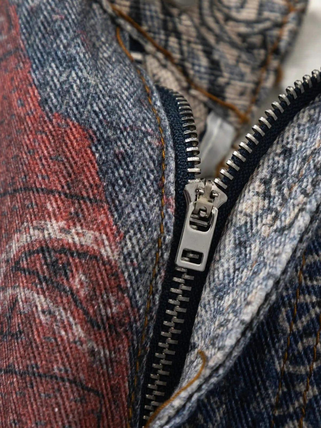 A detailed view of TALISHKO's digitally printed imitation jeans highlighting intricate zipper detail.