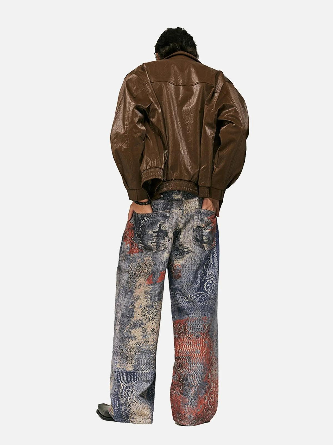 Model showcasing TALISHKO's digital print imitation jeans with a brown jacket from the back.