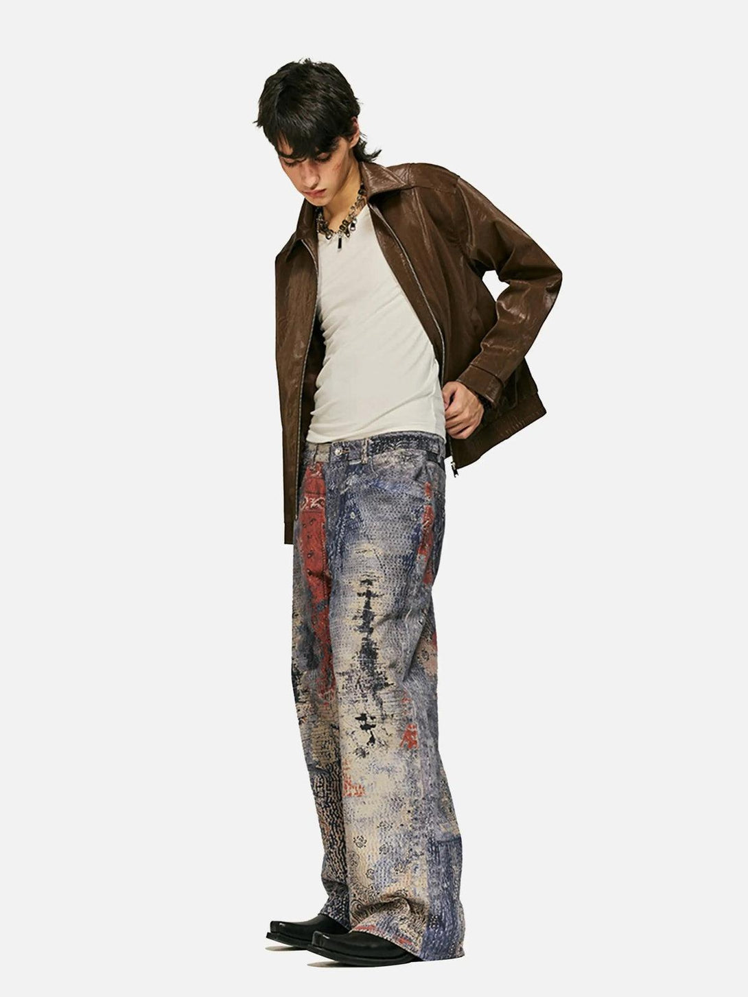 Model wearing TALISHKO's digitally printed imitation jeans with a brown jacket and white top.