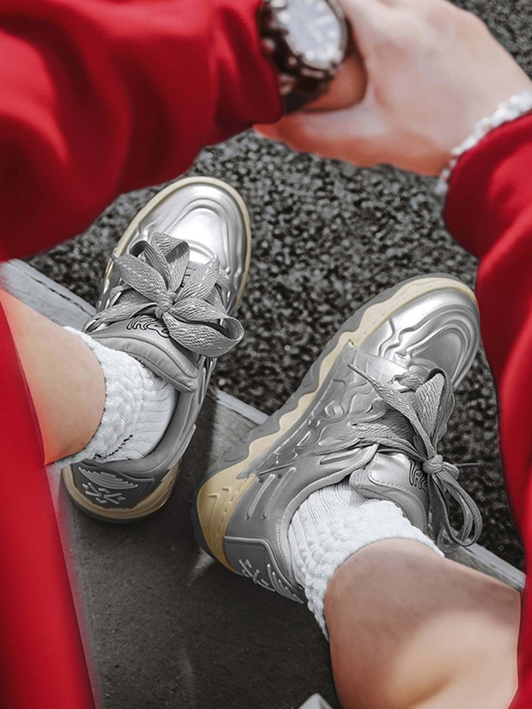 Casual shoes by TALISHKO in silver, worn with white socks and a red outfit, highlighting street style.