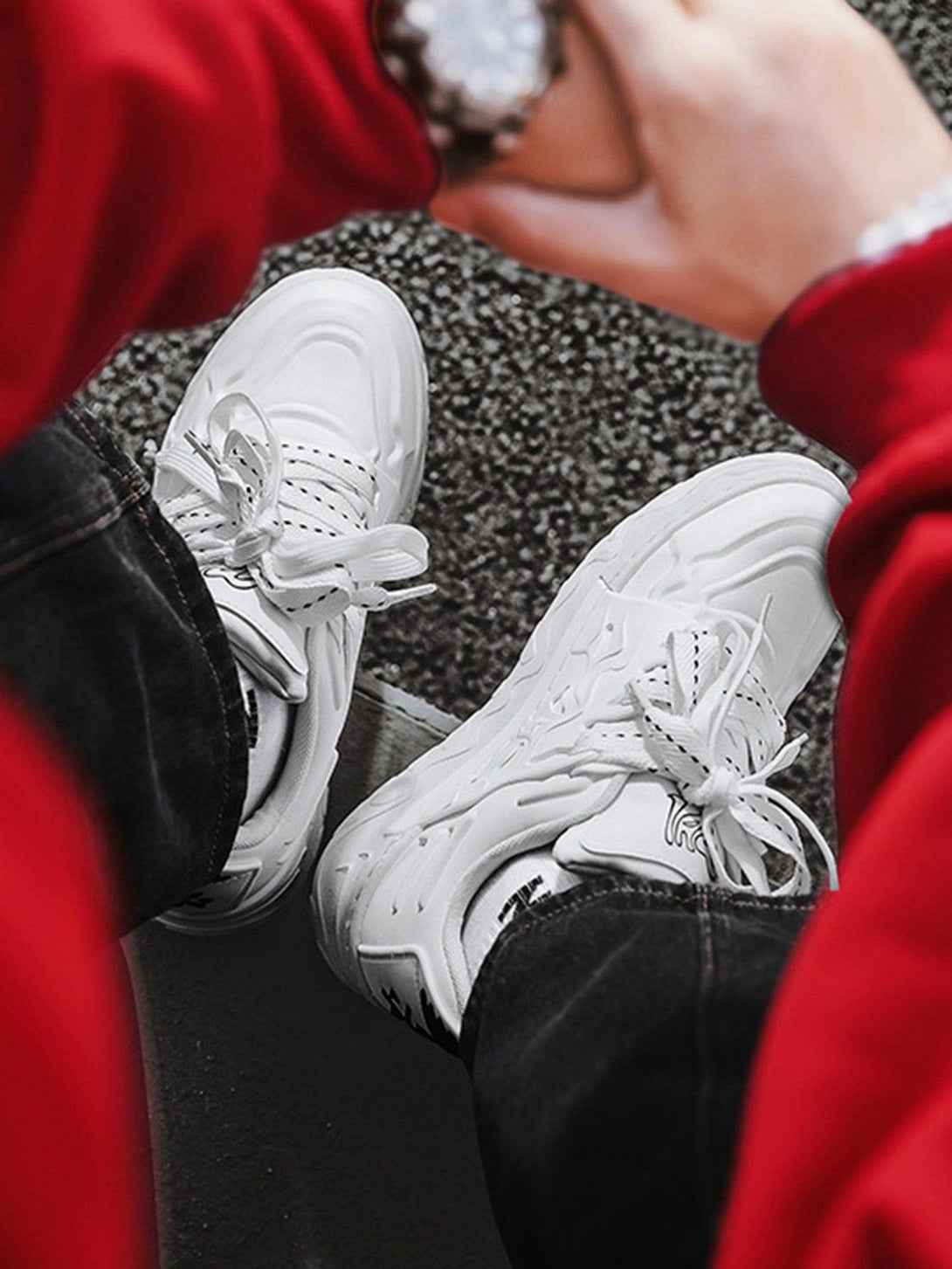 White TALISHKO casual plate shoes paired with black jeans, highlighting trendy street fashion.