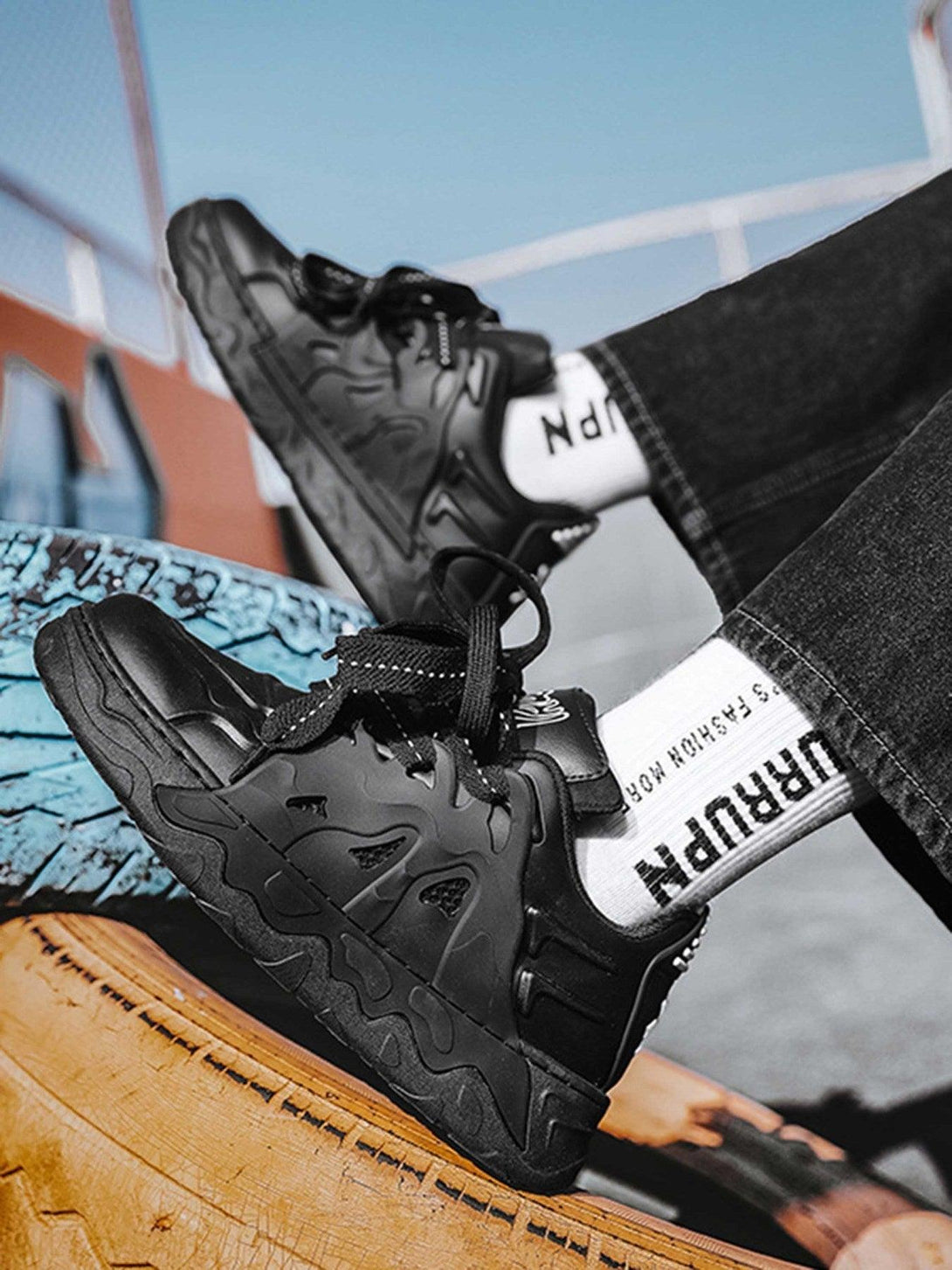 Black casual plate shoes by TALISHKO, side view emphasizing bold design and street vibe.