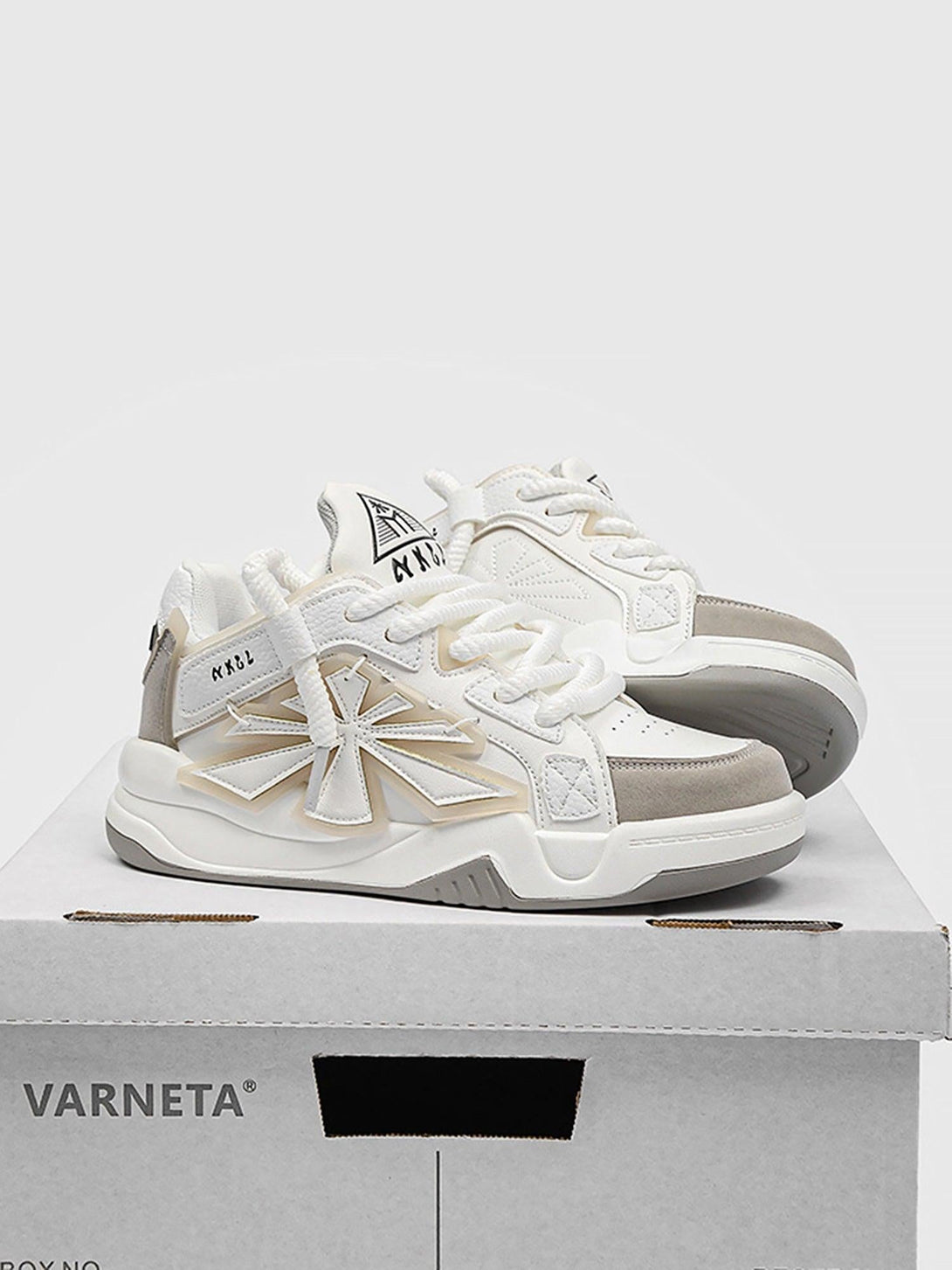 TALISHKO white casual preppy sneakers with bold star accents on a shoebox.