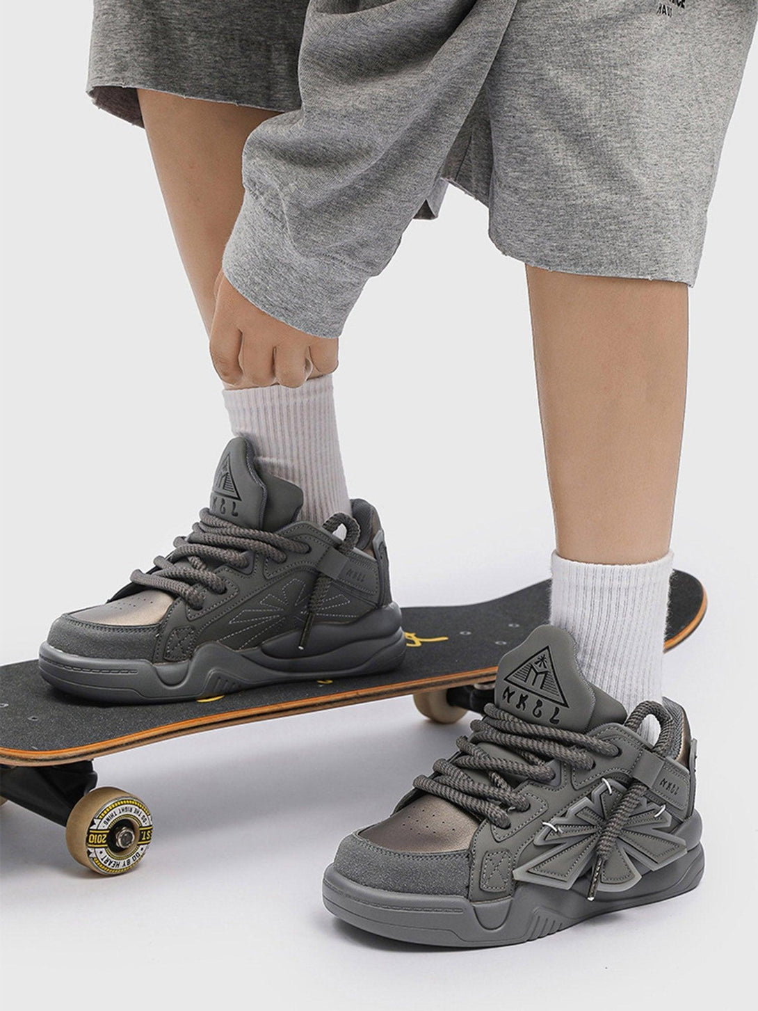 TALISHKO gray preppy sneakers paired with shorts, perfect for a casual, sporty look.