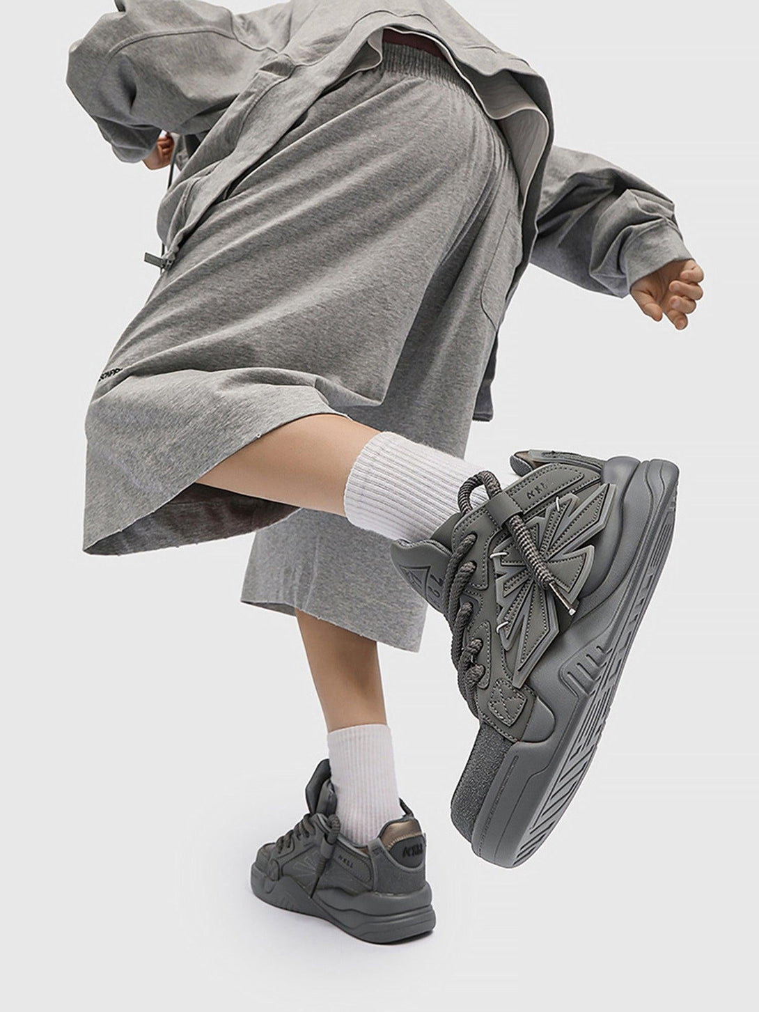 TALISHKO gray preppy sneakers worn with a relaxed outfit, perfect for a modern casual look.