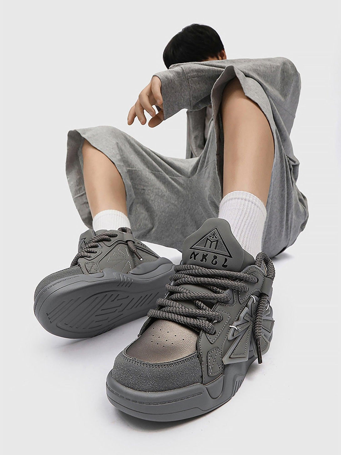 TALISHKO gray preppy sneakers paired with a relaxed outfit, highlighting modern street style.