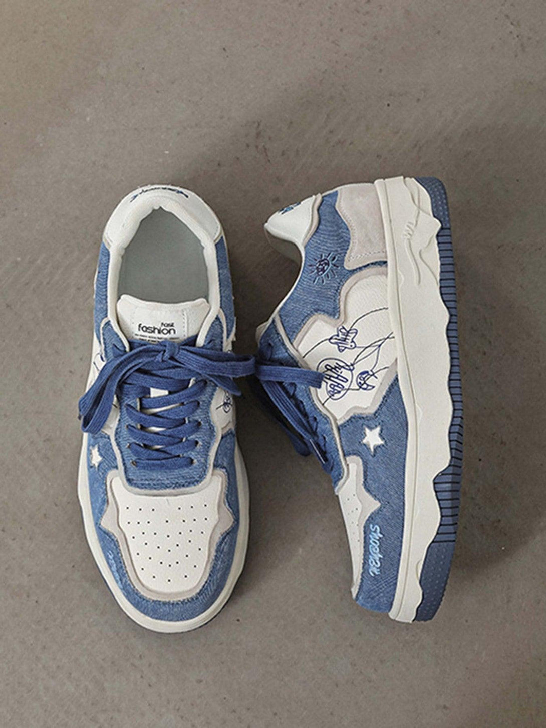 A detailed view of TALISHKO board shoes in blue, highlighting star designs and thick soles.