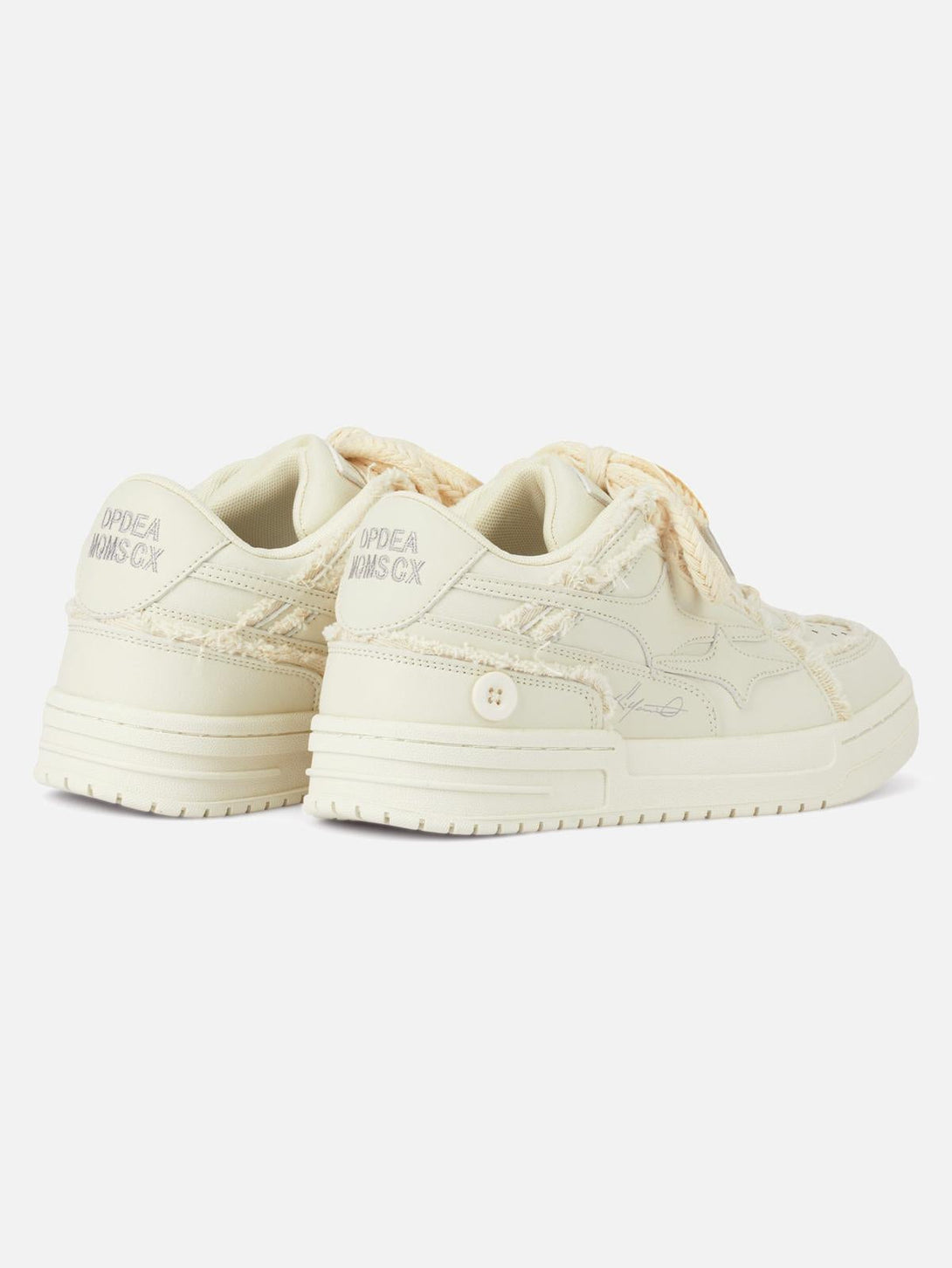 Back view of TALISHKO casual white board shoes with textured details and button accents.