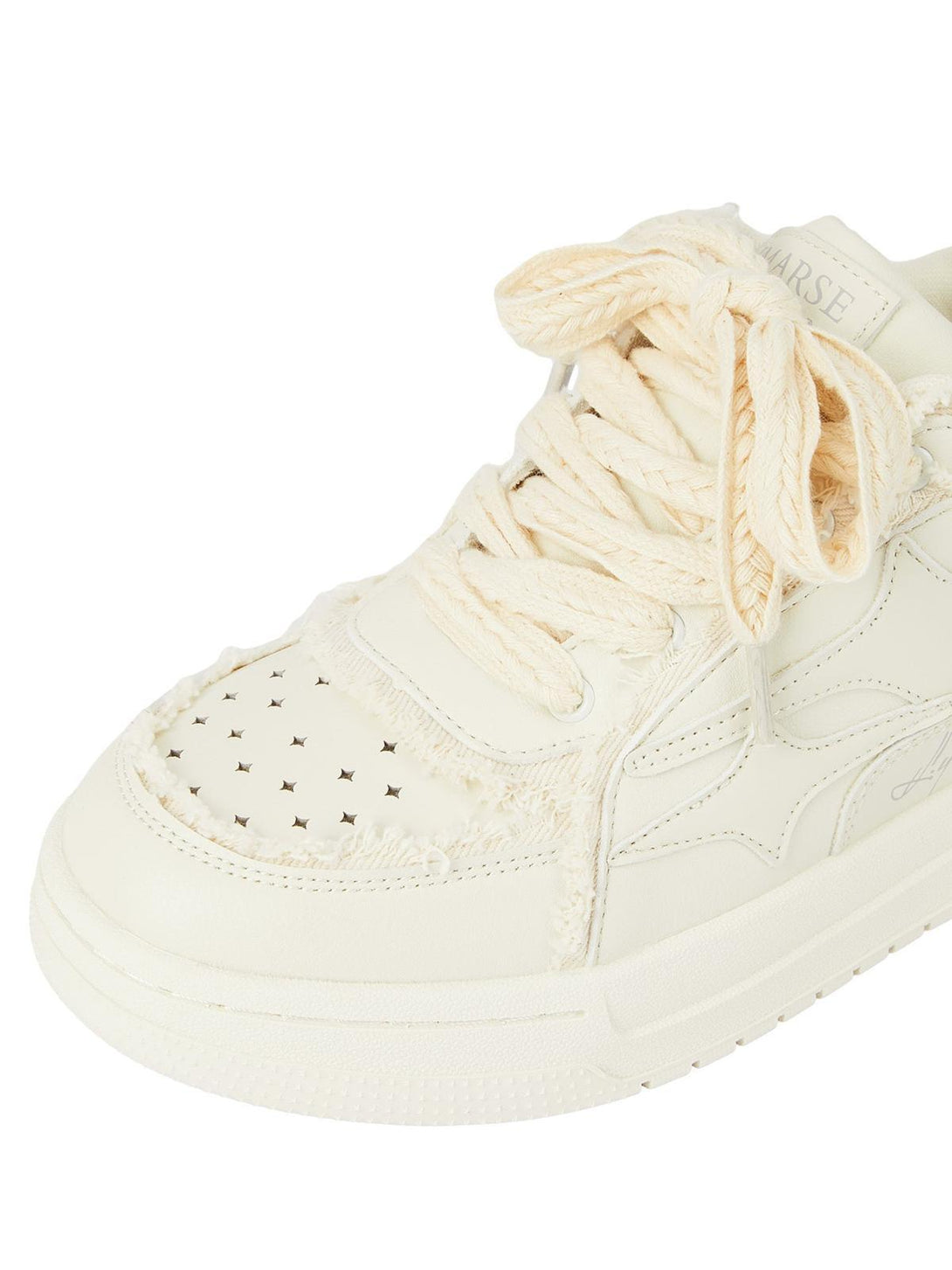 A detailed view of TALISHKO's casual board shoes, highlighting textured laces and perforations.