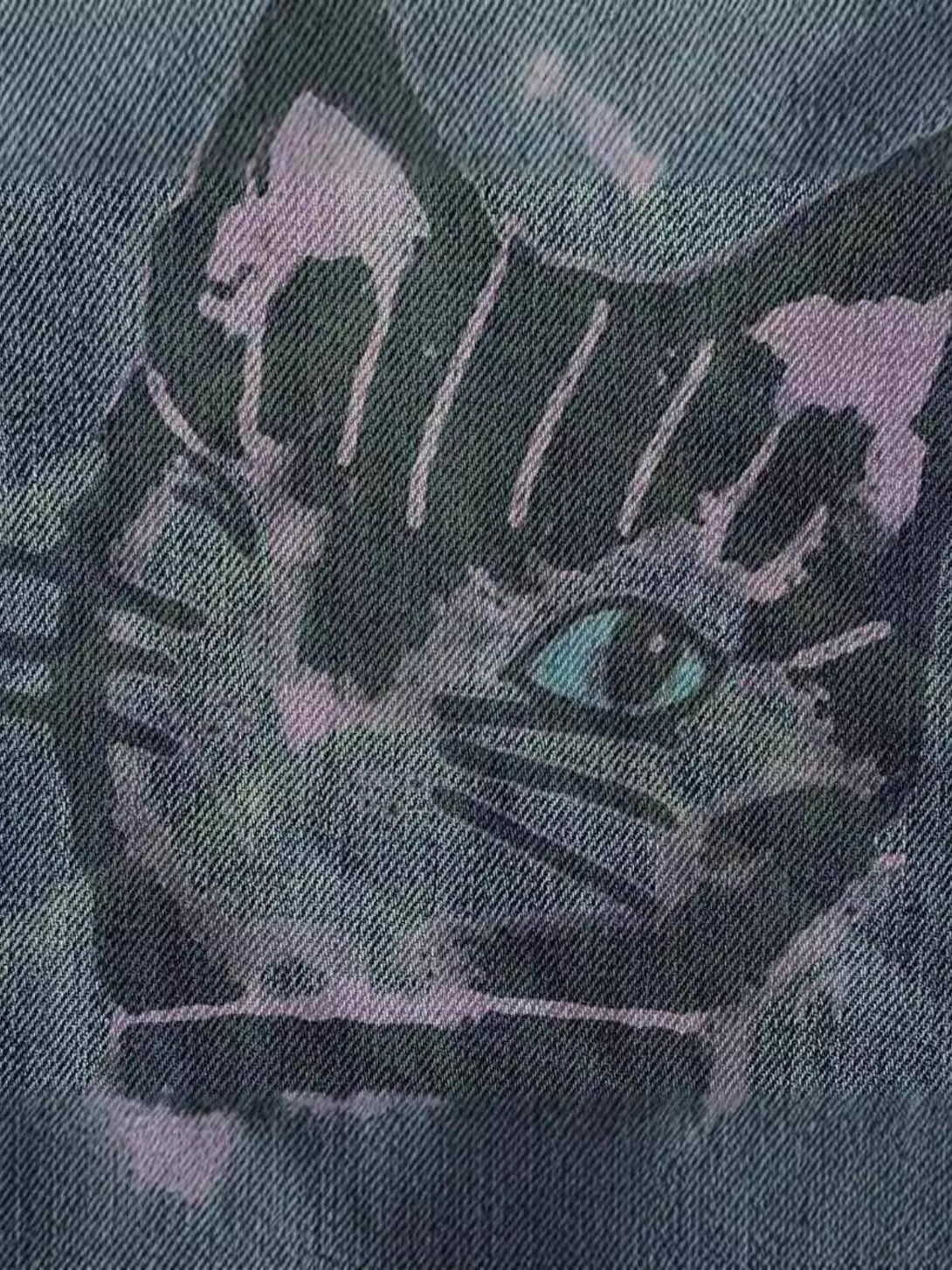 Cat graffiti print on denim by TALISHKO, showcasing artistic flair and urban style.