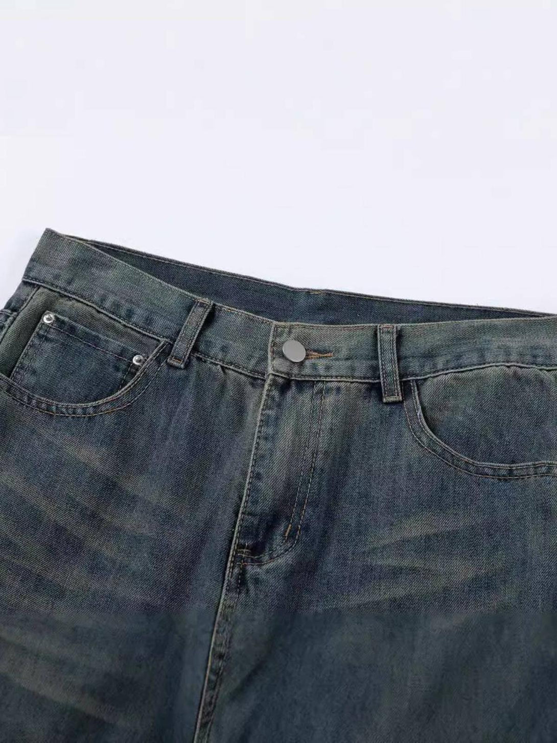 A close-up of TALISHKO jeans, highlighting the unique cat graffiti print on a dark denim fabric.