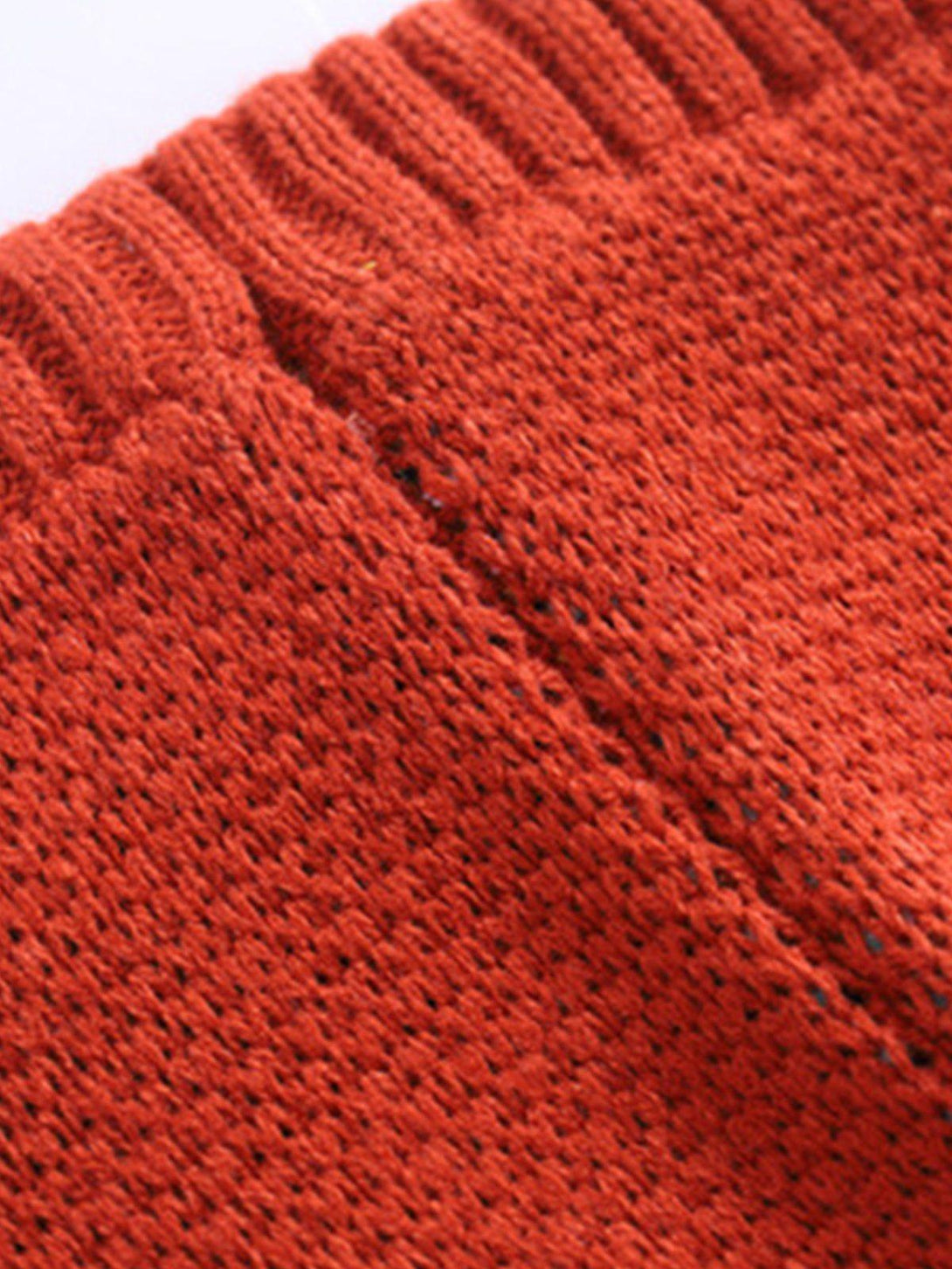 Focusing on the rich texture of a red knit bag by TALISHKO, showcasing expert craftsmanship.