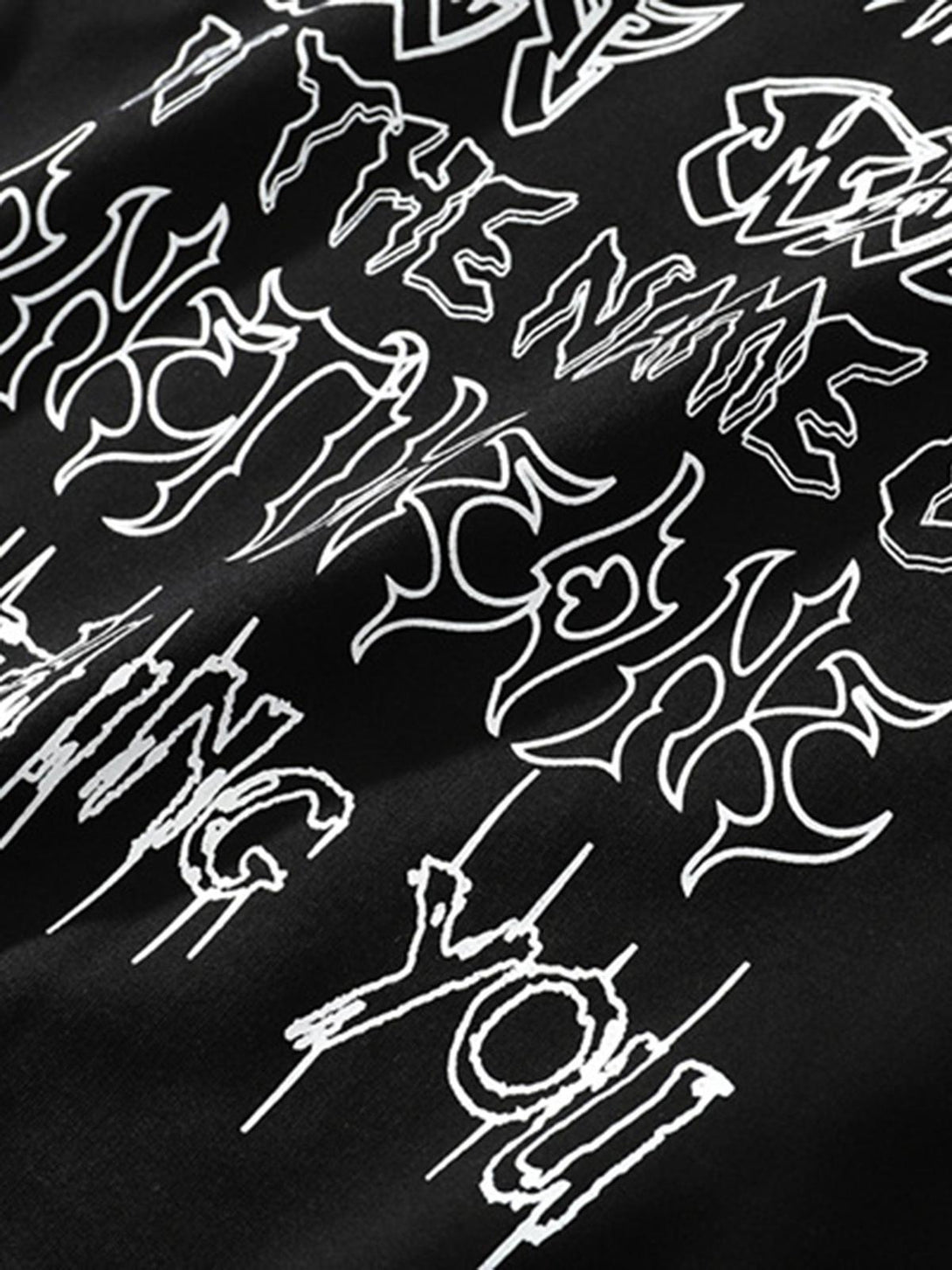 Intricate look at the bold lettering on a black oversized T-shirt by TALISHKO.