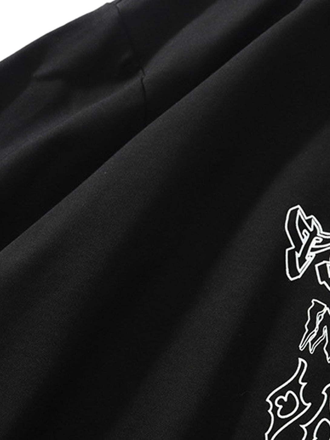 A tight crop highlighting the graphic design on a black oversized T-shirt by TALISHKO.