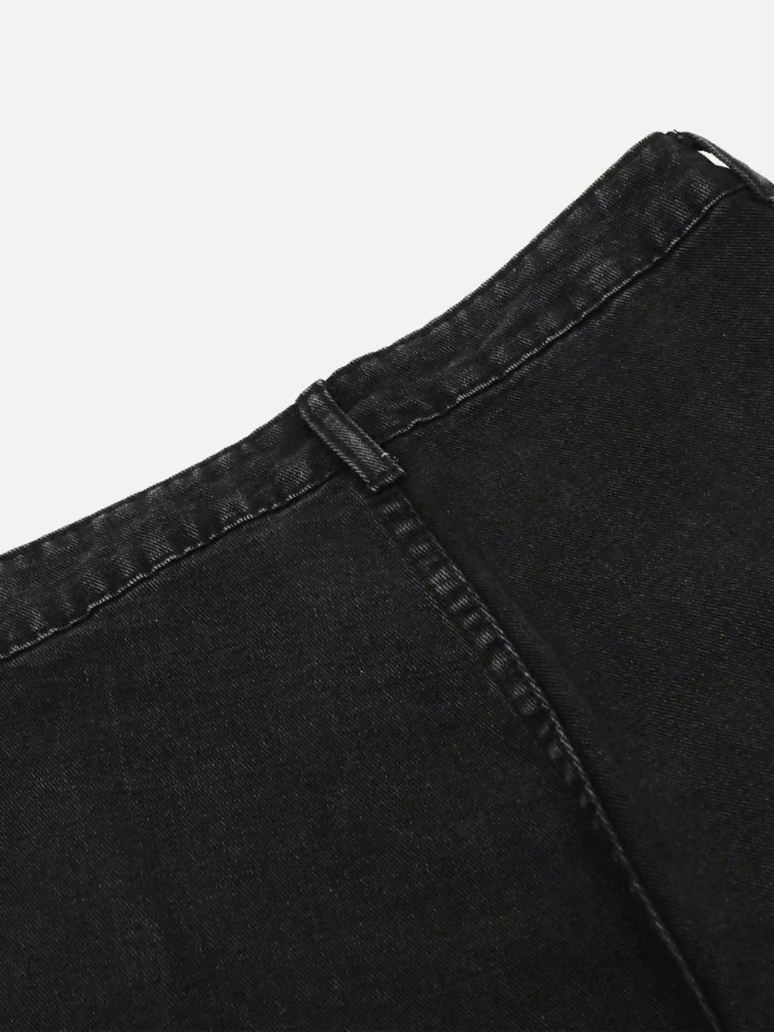 Detailed look at TALISHKO black cargo jeans, highlighting durable stitching and texture.